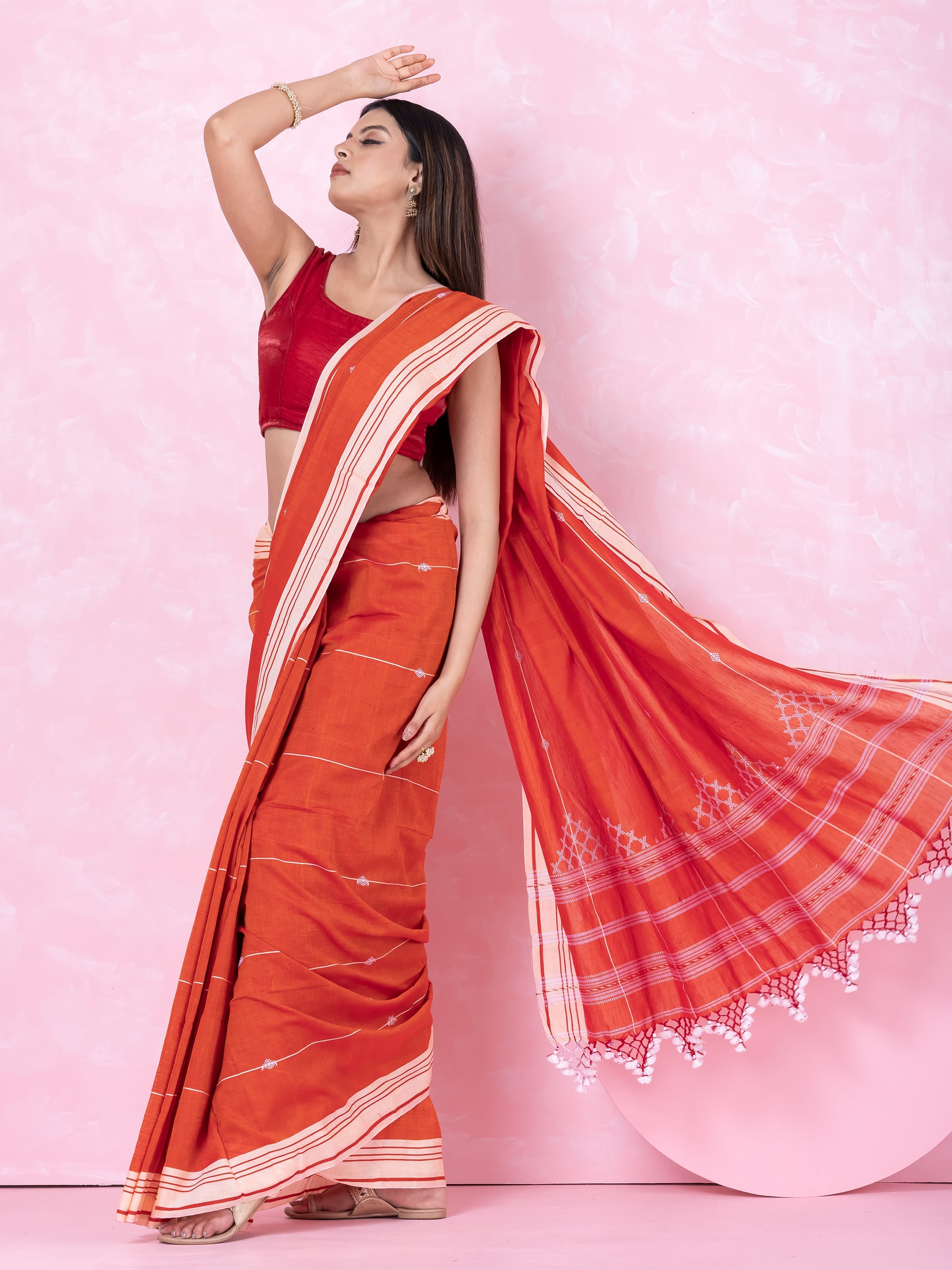 Orange- white handloom cotton saree named Rustic Reverie.