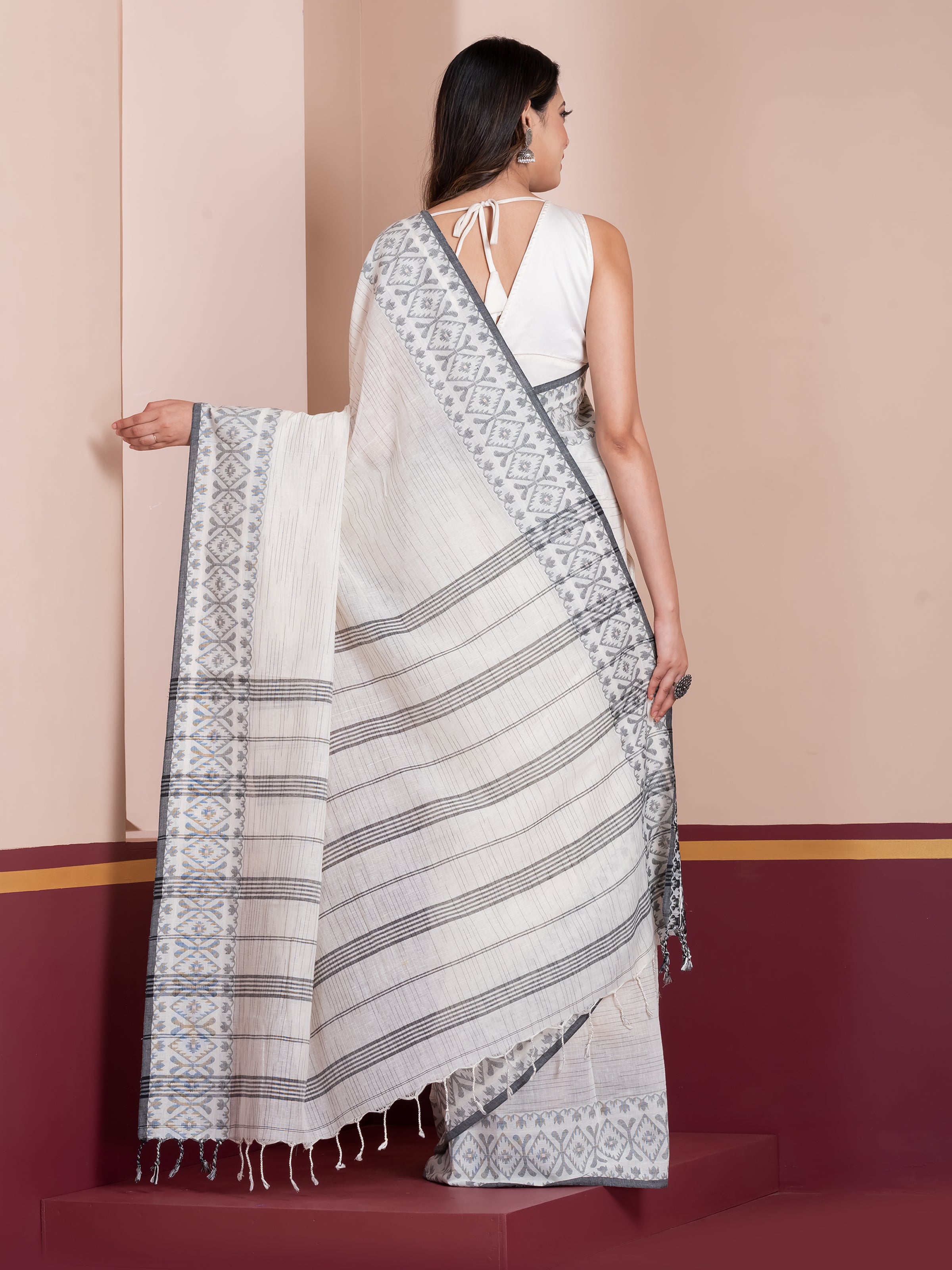 Handcrafted white khaadi cotton saree featuring Jamdani Paar design