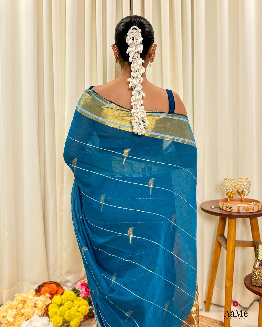 Women wearing lightweight blue mulmul cotton saree designed for long festive gatherings and easy movement