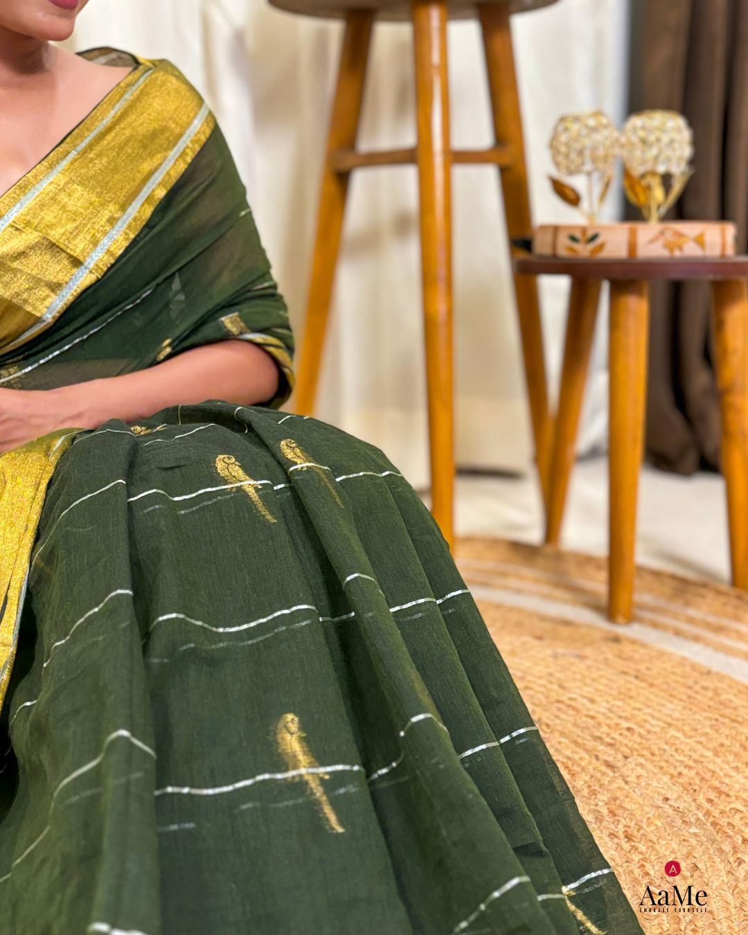 Close-up view of soft green mulmul cotton saree fabric with breathable texture