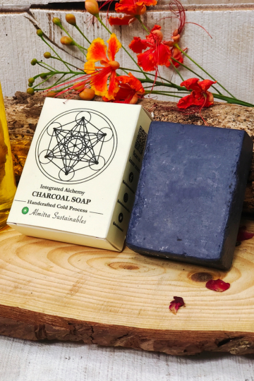 Chocolate coffee handmade cold process soap with Almitra Sustainable packaging placed on rustic wooden surface with flowers and natural ingredients, eco-friendly artisan soap bar designed for deep cleansing, exfoliation and natural skincare.