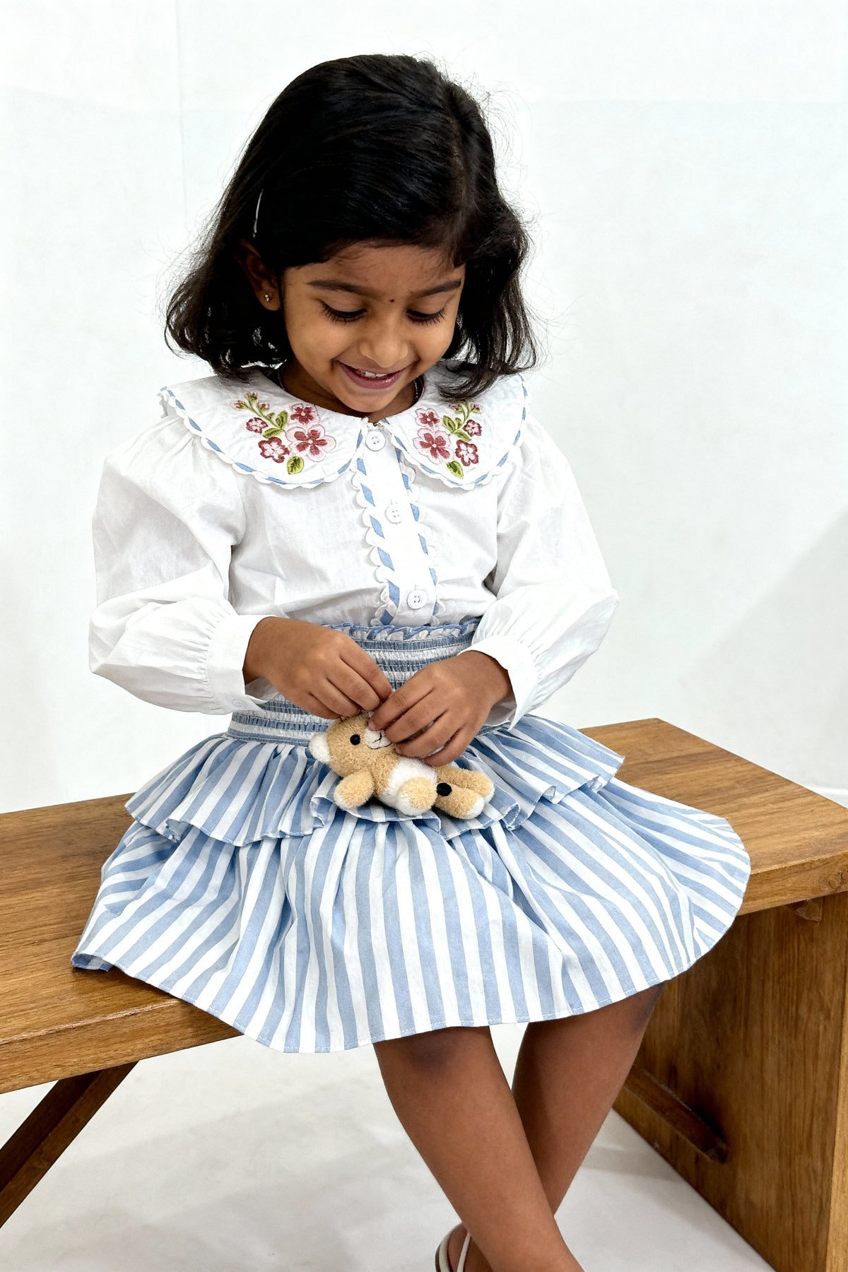 Capri Blouse and Amalfi Skort set flat lay showing both pieces in GOTS-certified organic cotton
