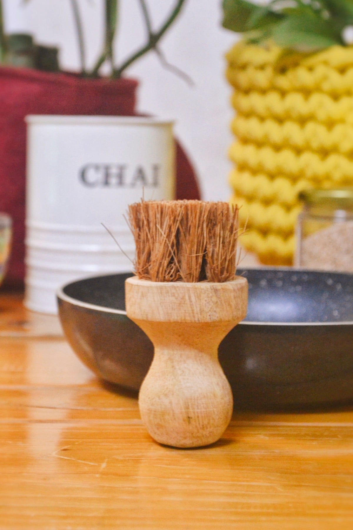 Close-up of Almitra Sustainable wooden dish scrubber with dense coconut fibre bristles for eco-friendly plastic-free kitchen cleaning.