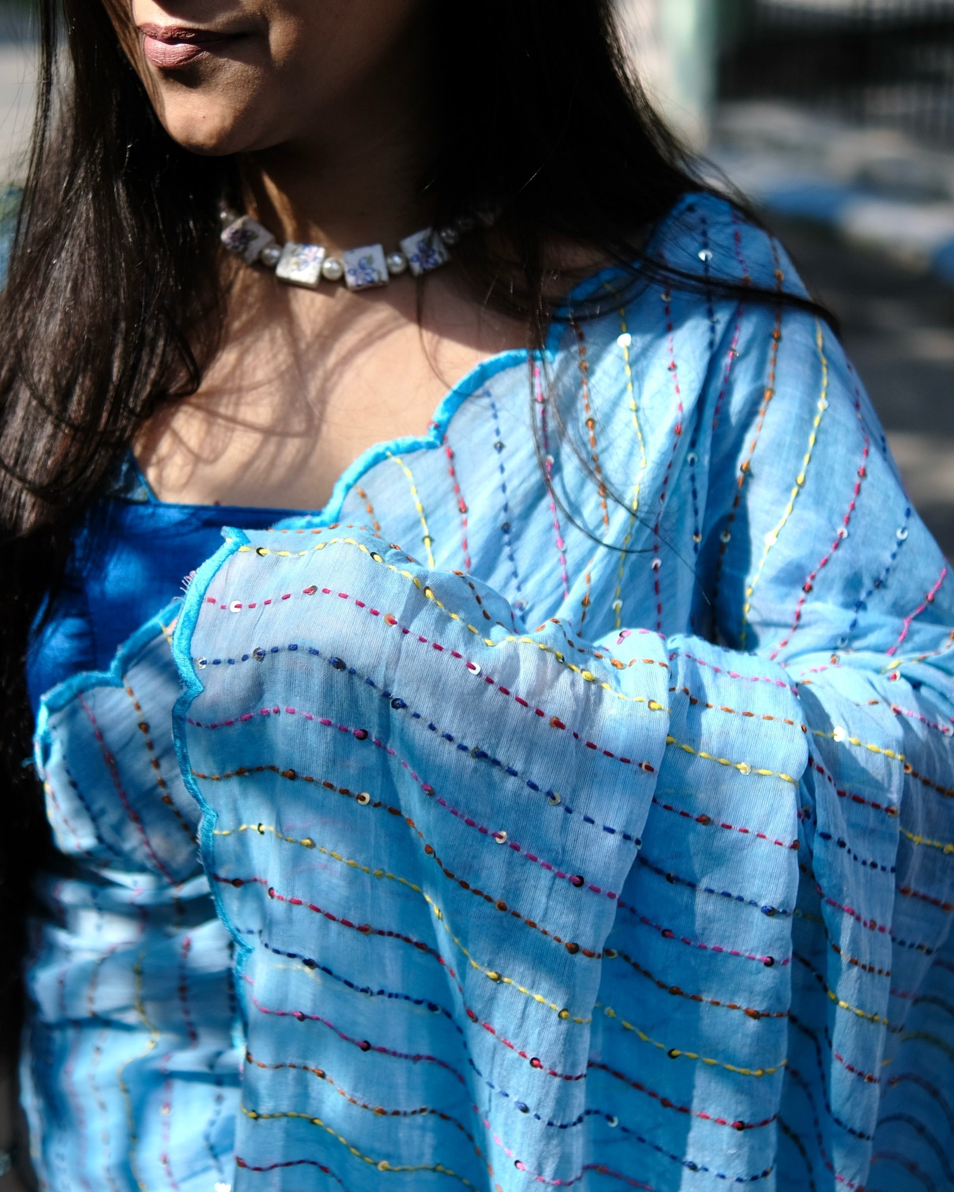 Blue mulmul cotton saree with colourful embroidery and sequins, a breathable saree for festive occasions and everyday elegance.