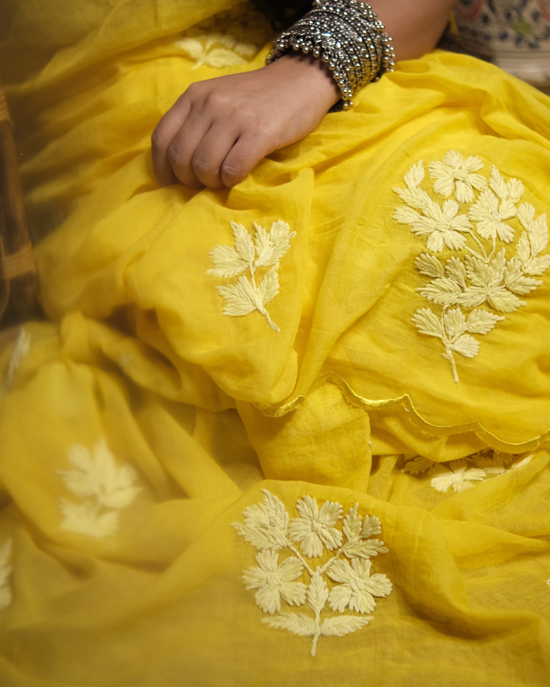 Kasturi yellow chikankari embroidered mulmul cotton saree, a lightweight breathable saree for summer and festive wear.