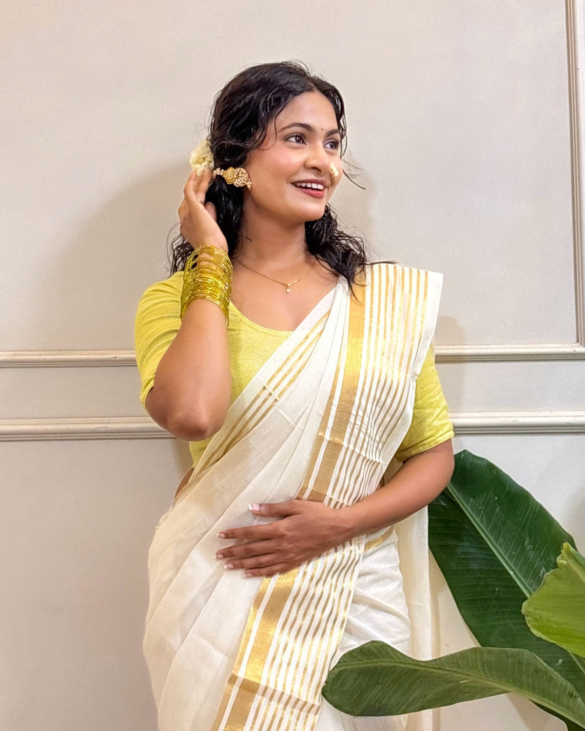 White mulmul cotton saree featuring elegant golden border for Onam celebrations