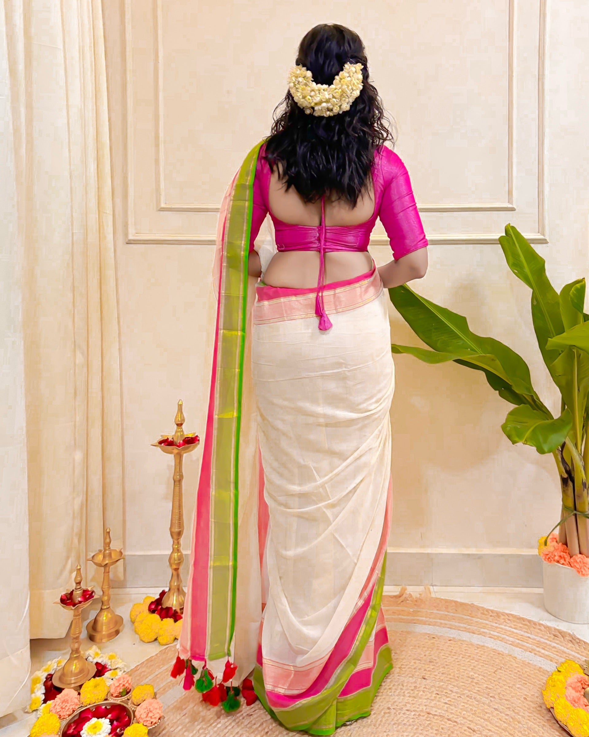 White mulmul cotton saree featuring Kerala-inspired Onam festive border