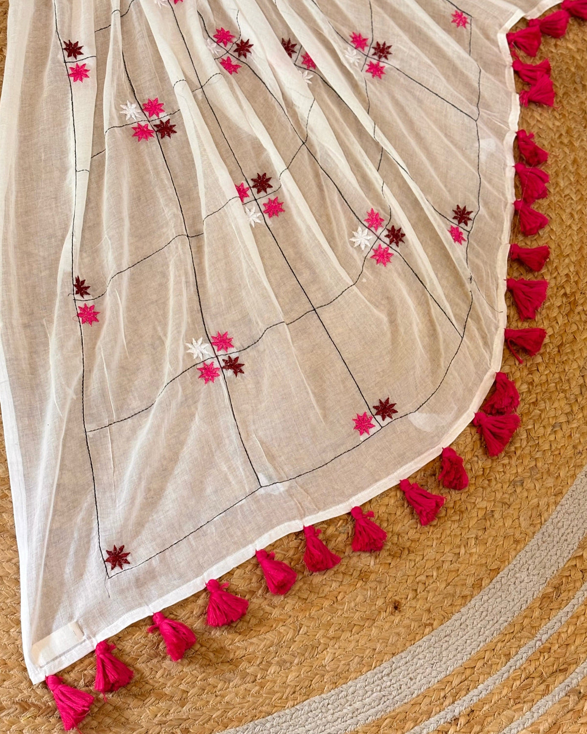 Floral white mulmul cotton saree featuring elegant Onam festive styling