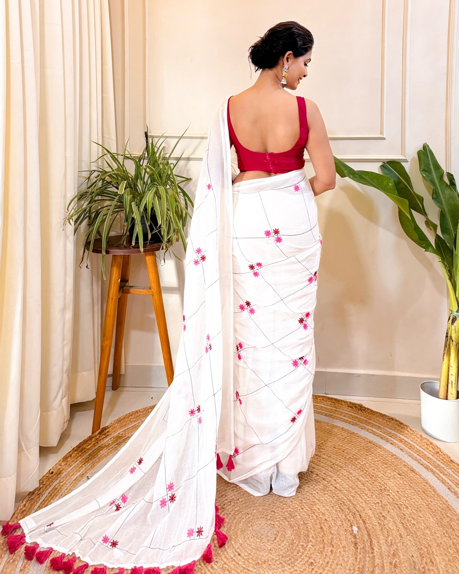 Designer white Onam cotton saree with pink florals and graceful ethnic appeal