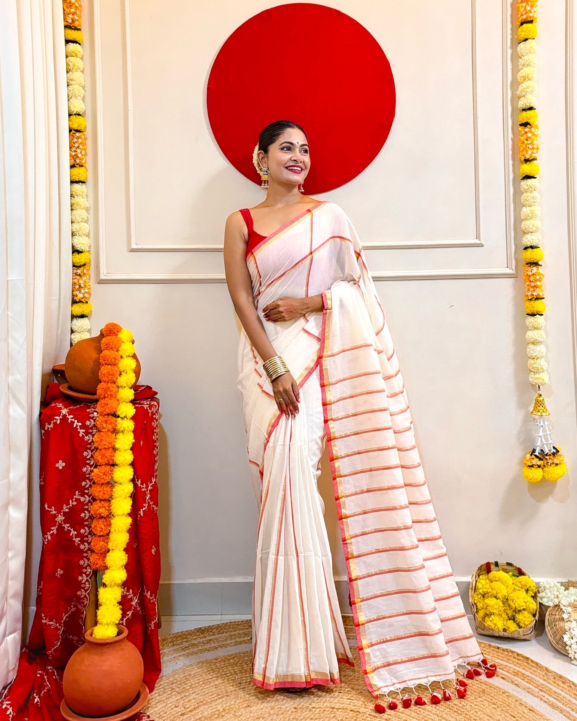 Laal Sada mulmul cotton saree featuring bold checks and traditional ethnic appeal