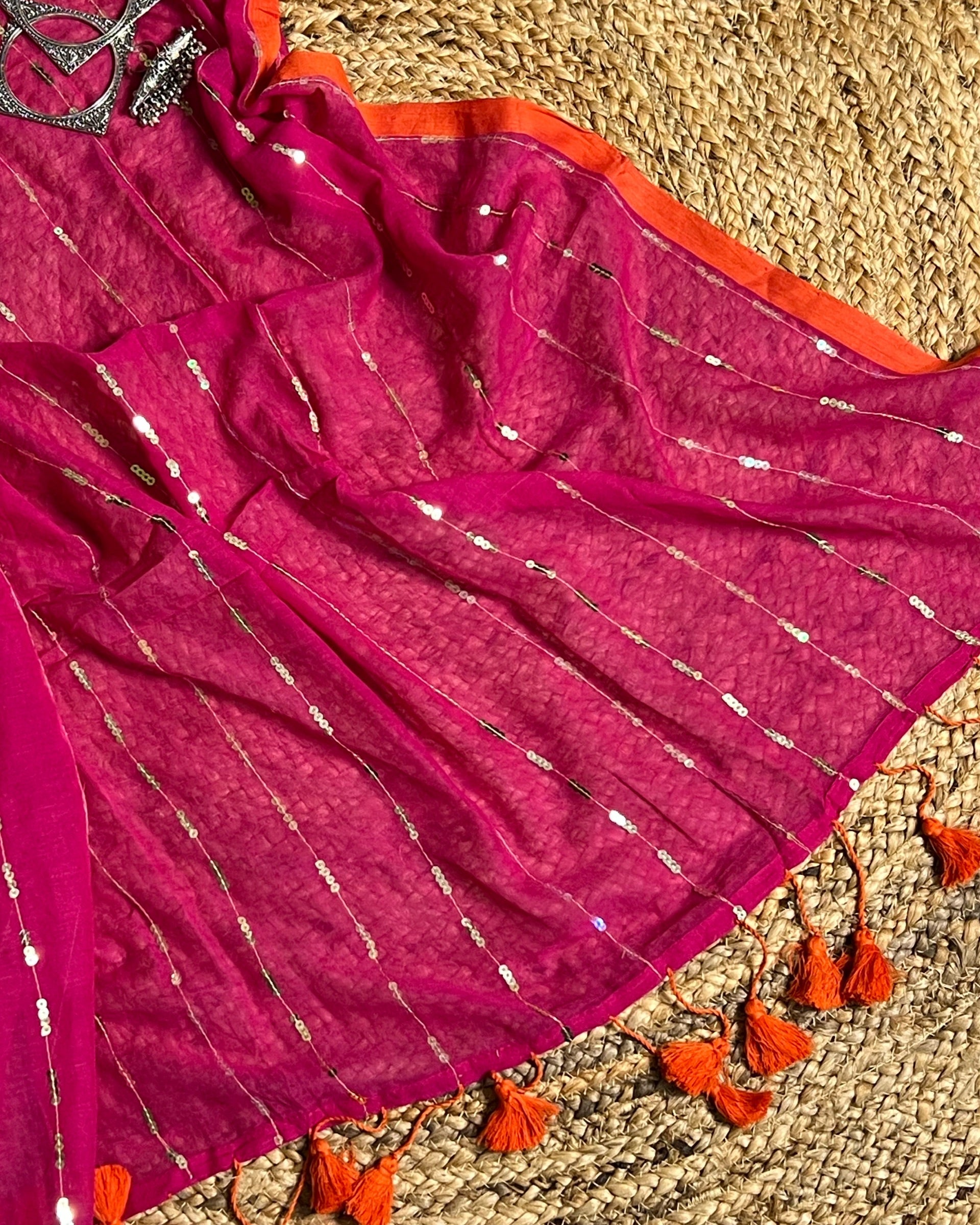 Soft and Comfortable mulmul cotton saree in pink rani shade with sequin emblishment for festive or party wear at reasonable price