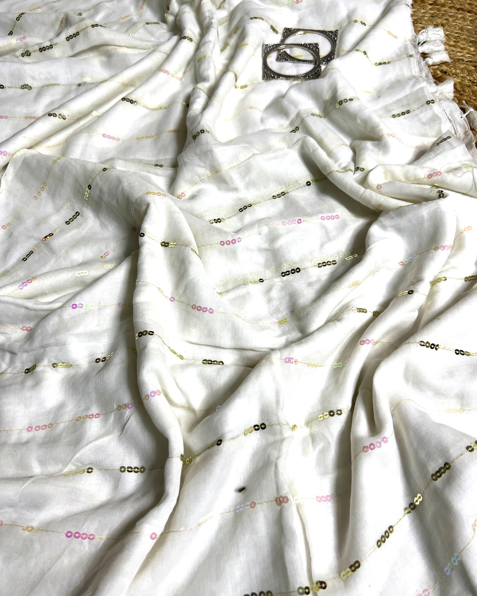 Sequins embellished white cotton saree featuring elegant linen organza detailing