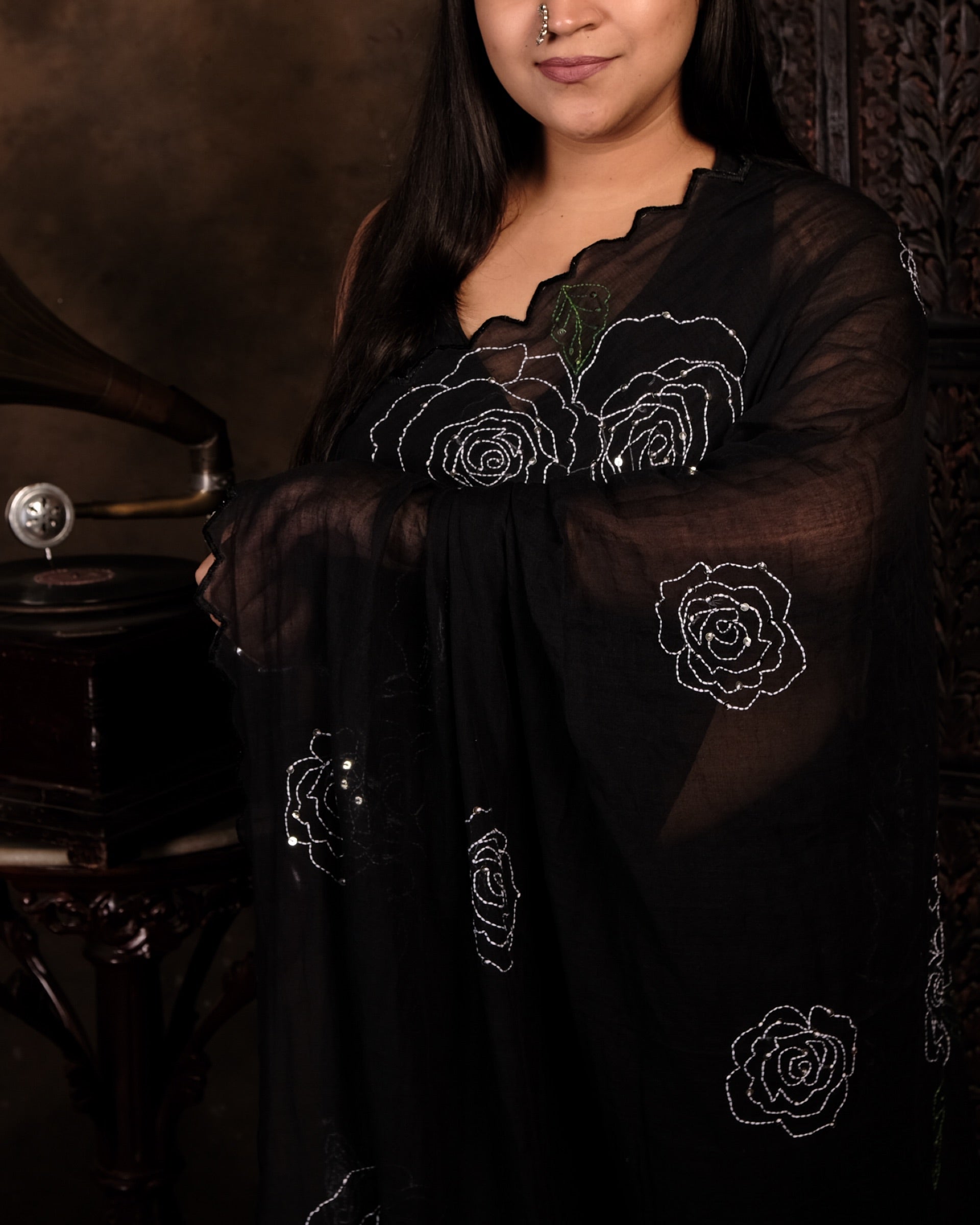 Soft and comfortable light weight black mulmul cotton saree by Shopaame with rose embroidery sequins embellished. Ideal for day time wear festive party wear