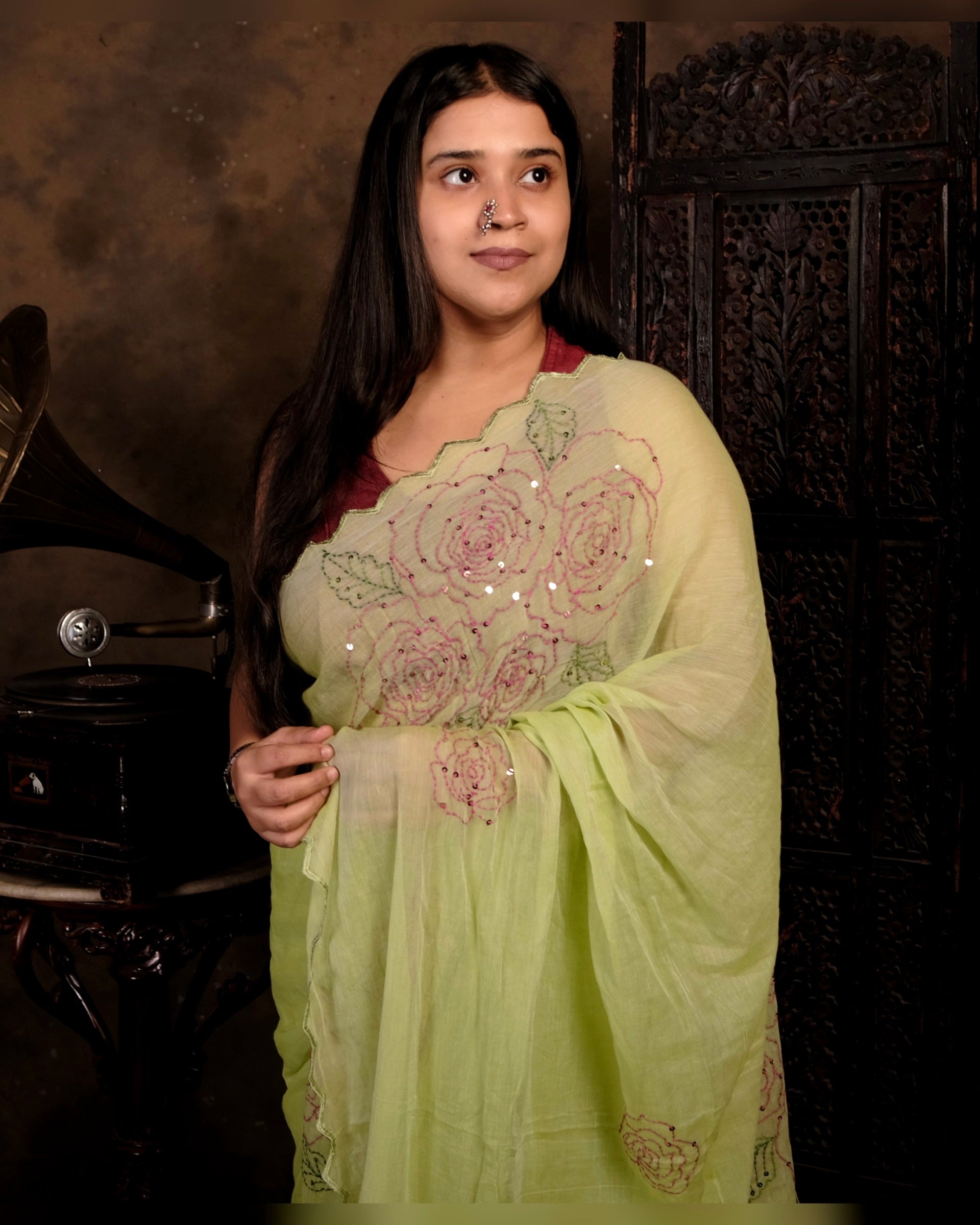 Green mulmul cotton saree with rose detailing and sequins, a breathable saree for festive occasions and summer days.