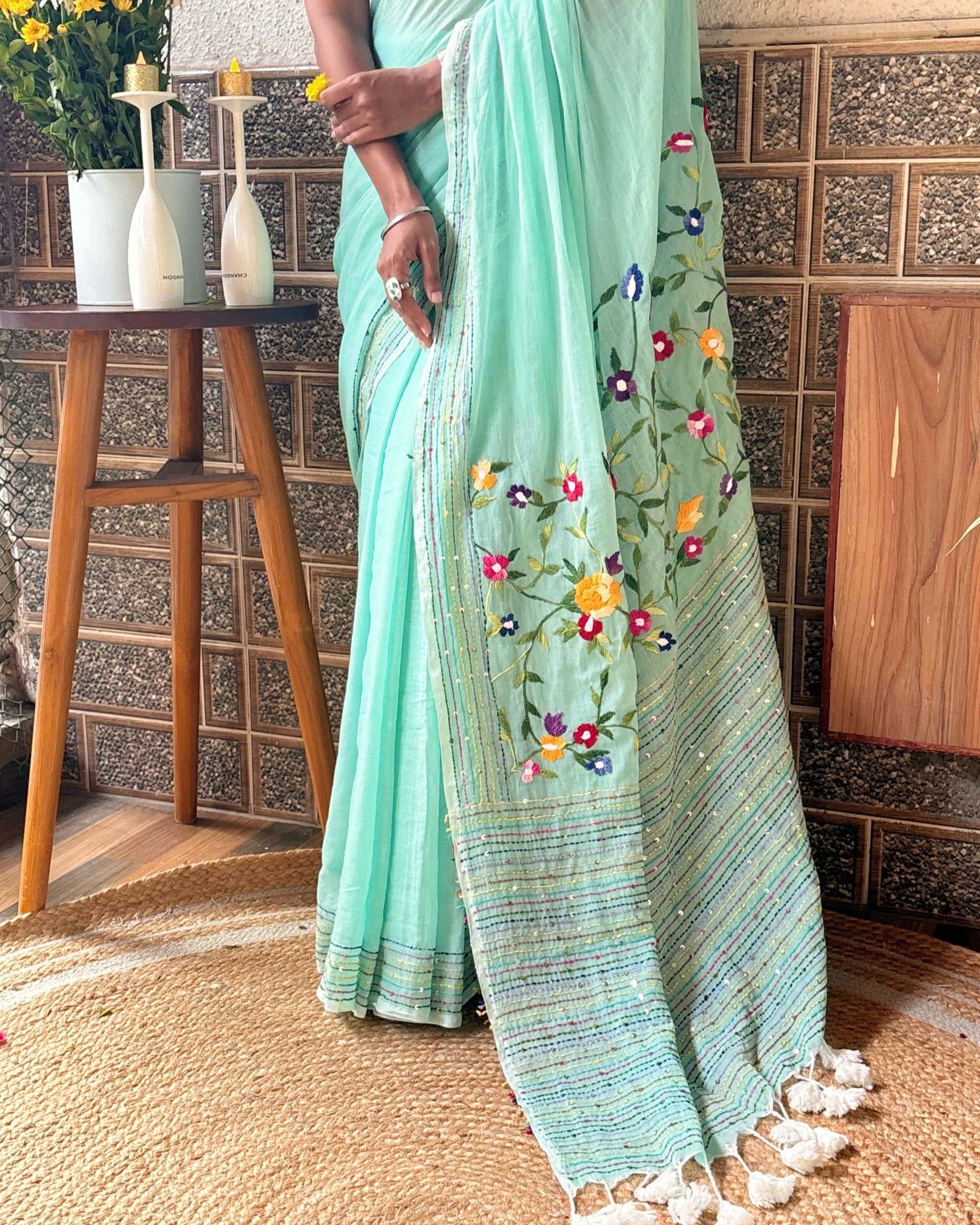 Light green cotton mulmul saree with floral embroidery details