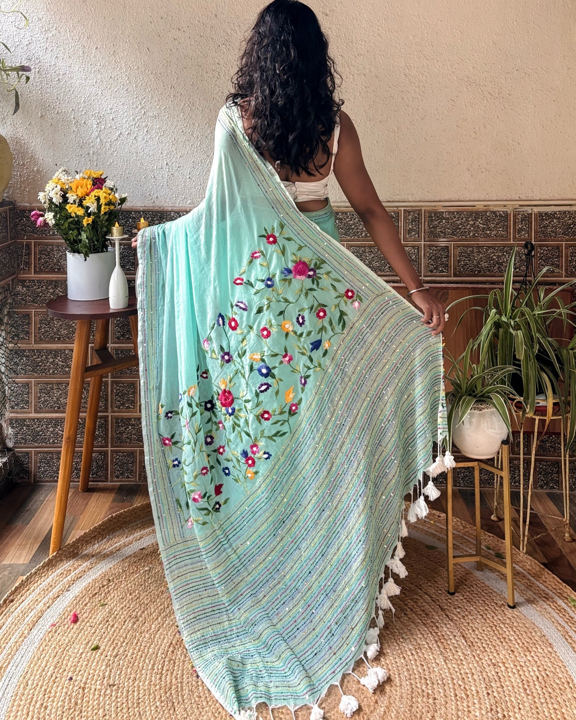 Woman wearing a soft green mulmul cotton saree for everyday comfort