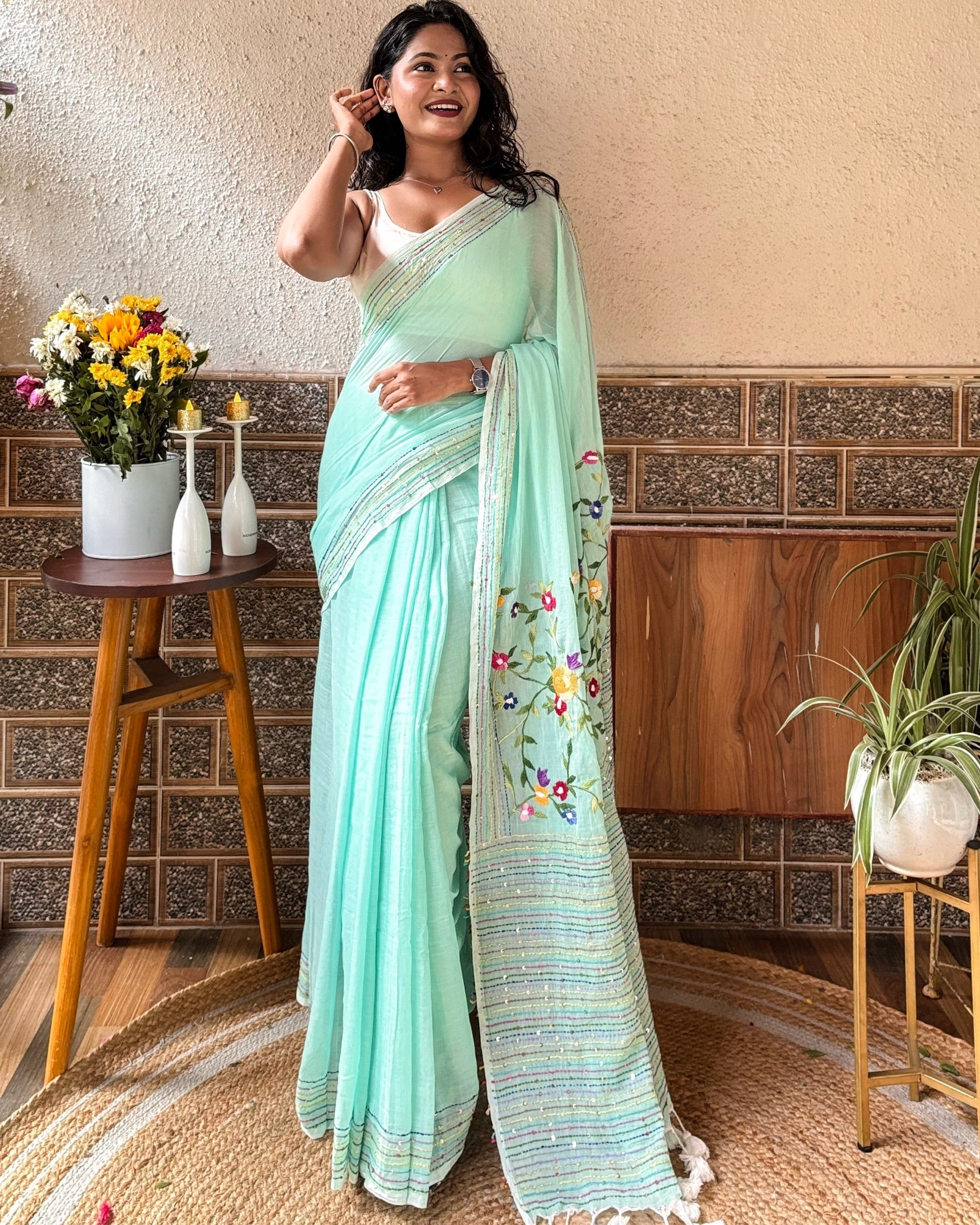 Model wearing a soft green mulmul cotton saree with a relaxed drape and breathable handcrafted fabric
