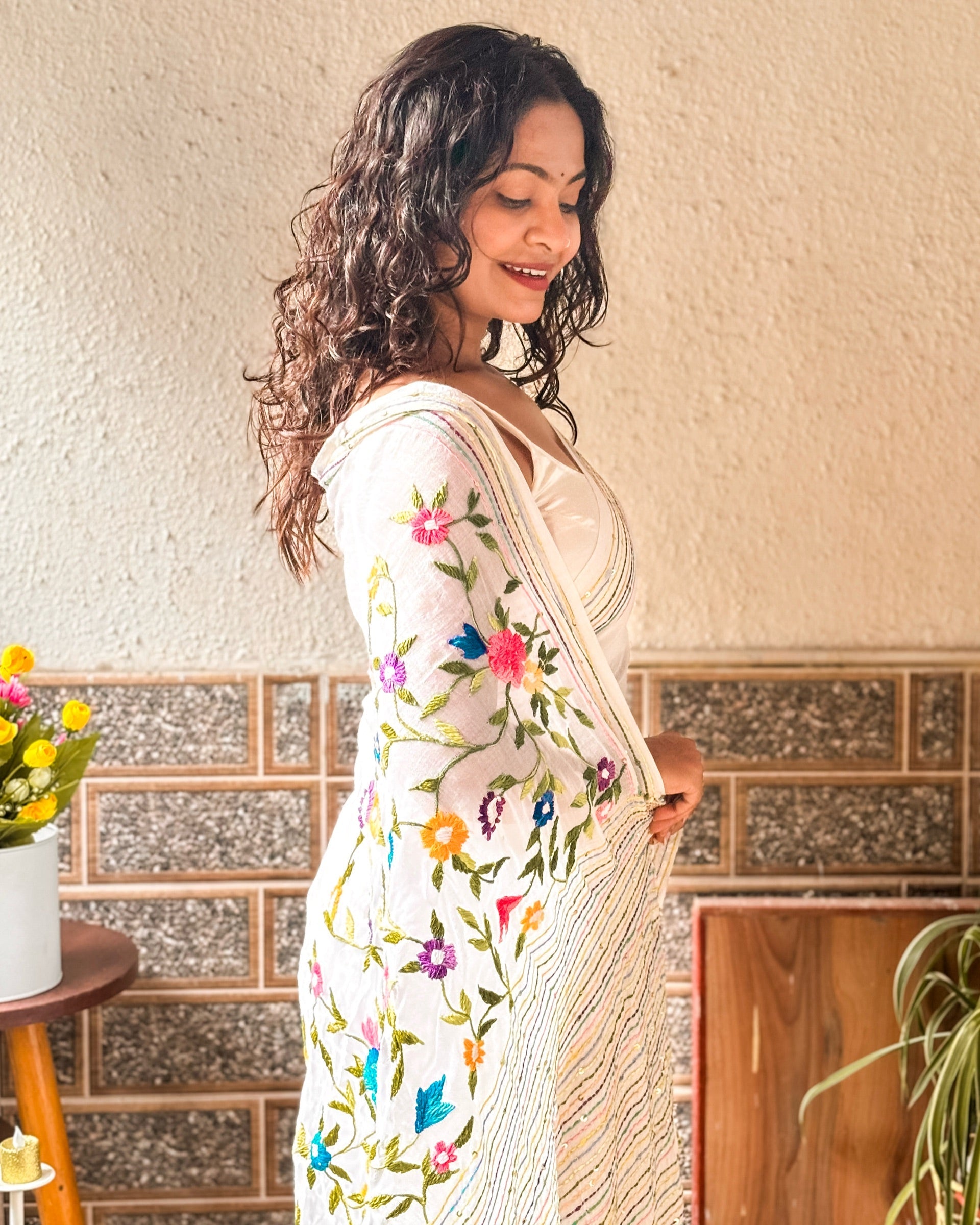 Handcrafted white saree featuring delicate floral embroidery from the Frosted Floral Muse collection
