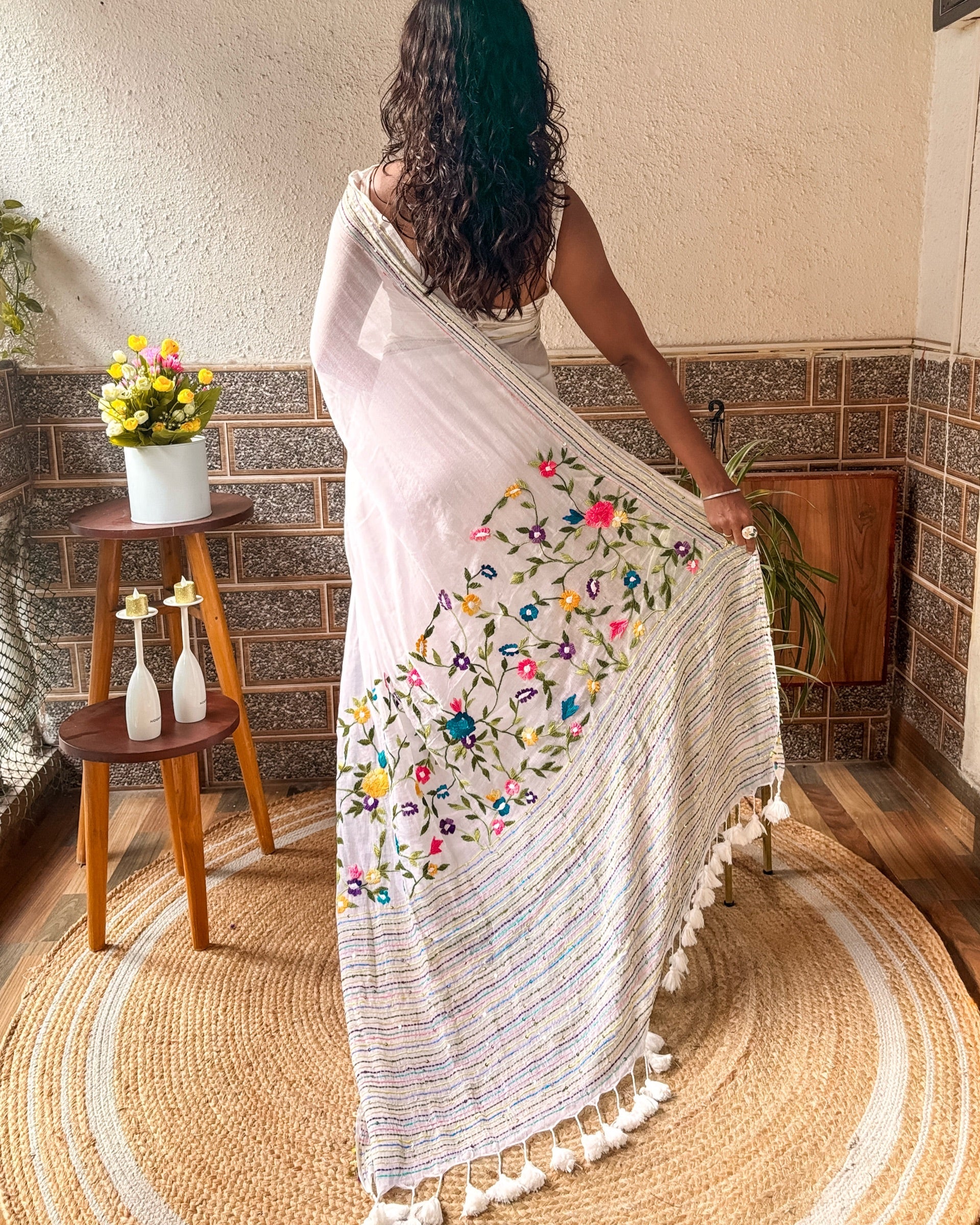 Handcrafted white saree featuring delicate floral embroidery from the Frosted Floral Muse collection