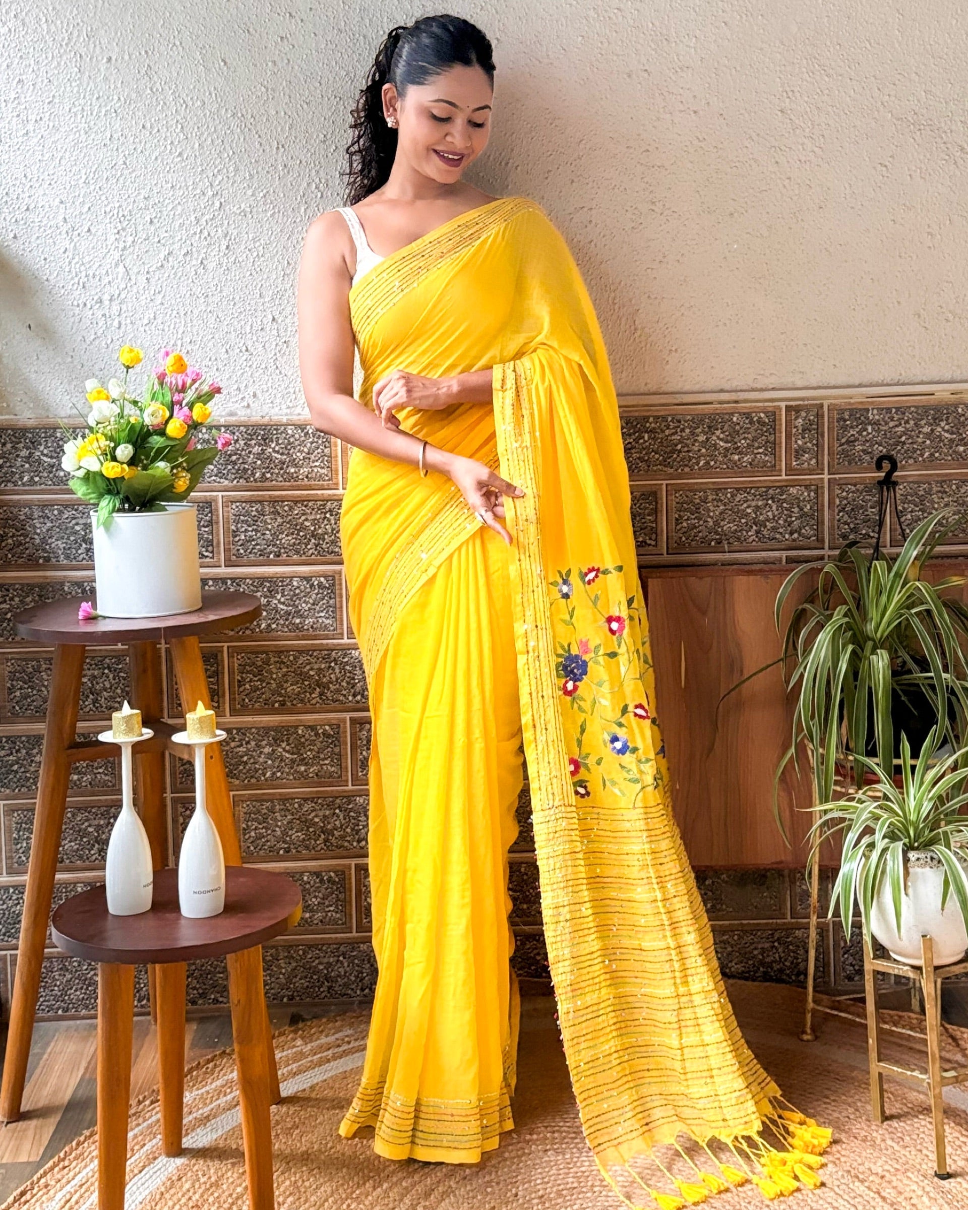 Bright yellow cotton mulmul saree with detailed embroidery work