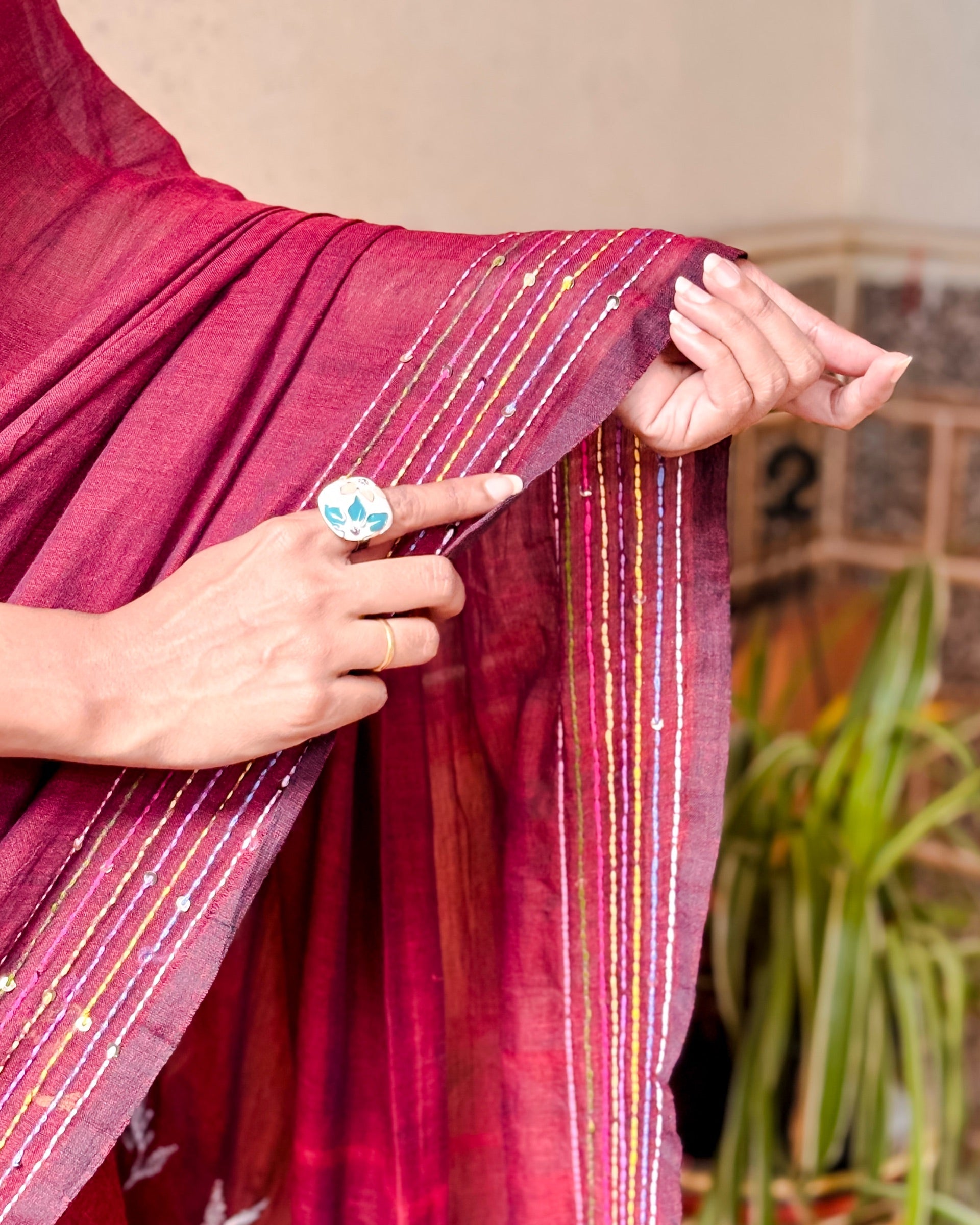 Handcrafted maroon mulmul cotton saree featuring soft breathable fabric and elegant thread work