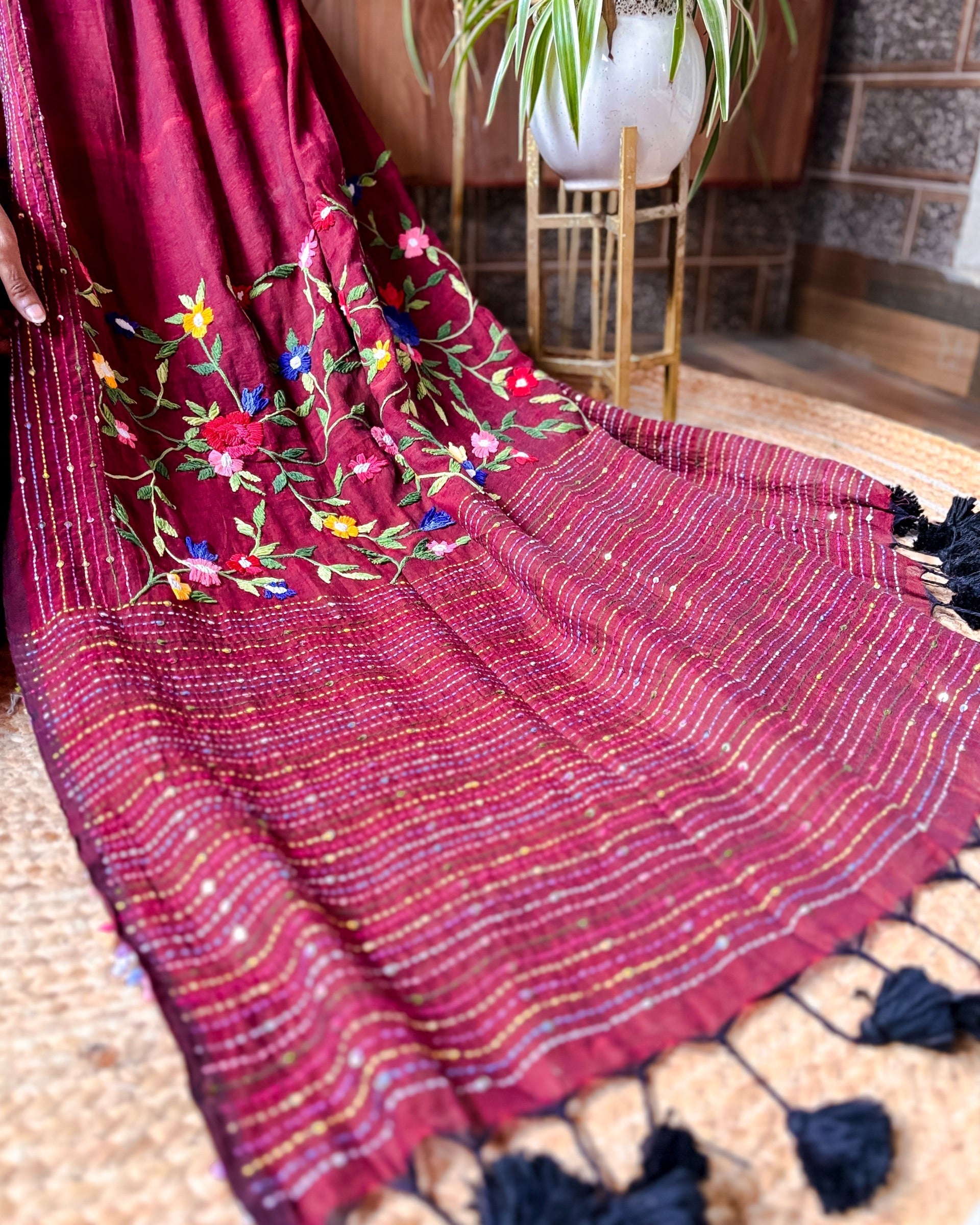 Handcrafted maroon mulmul cotton saree featuring soft breathable fabric and elegant thread work