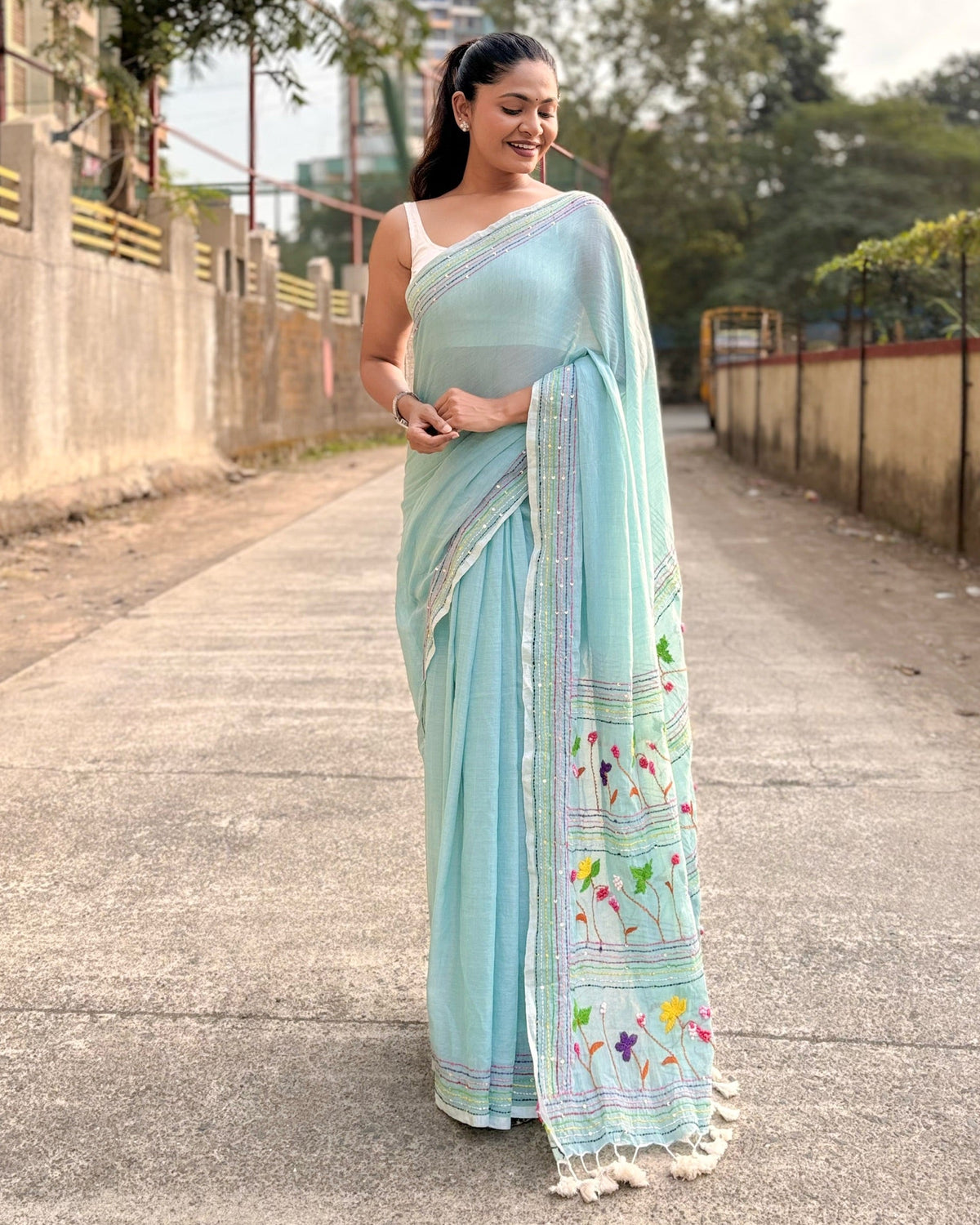 mulmul cotton saree in cyan color featuring elegant embroidery