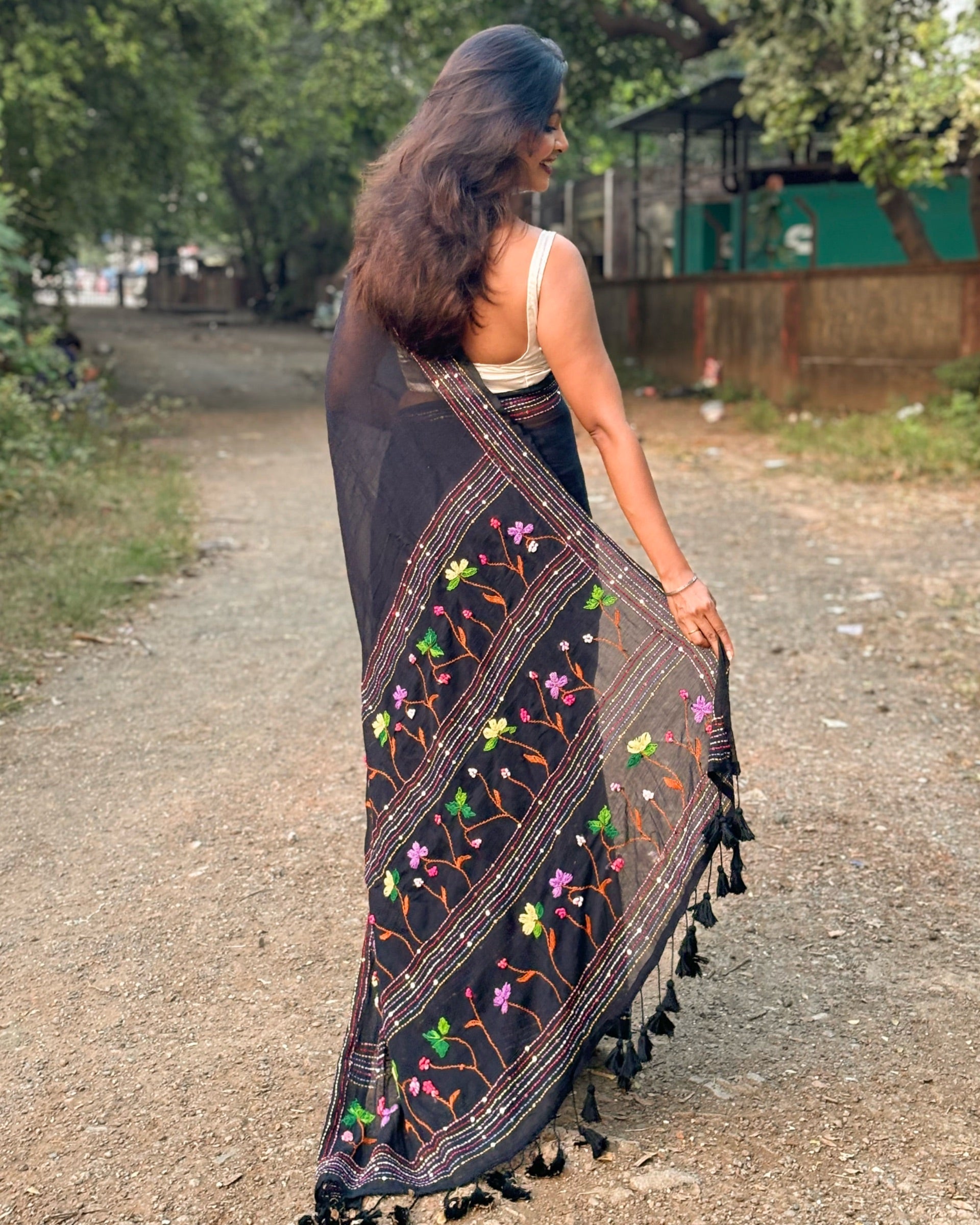 Model wearing Noir Petal Nocturne black mulmul cotton saree with delicate embroidery