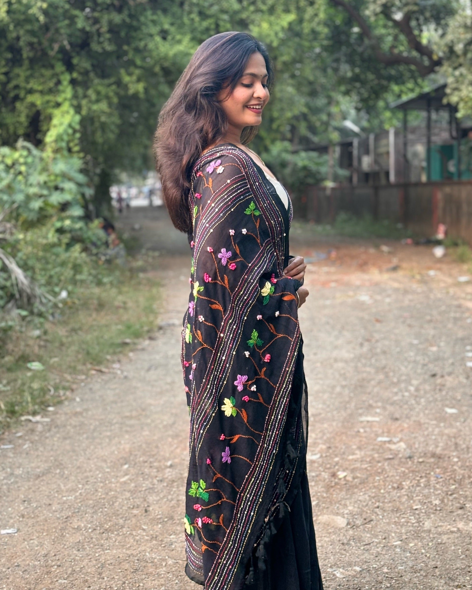 Elegant drape of Noir Petal Nocturne black mulmul saree with floral embroidery