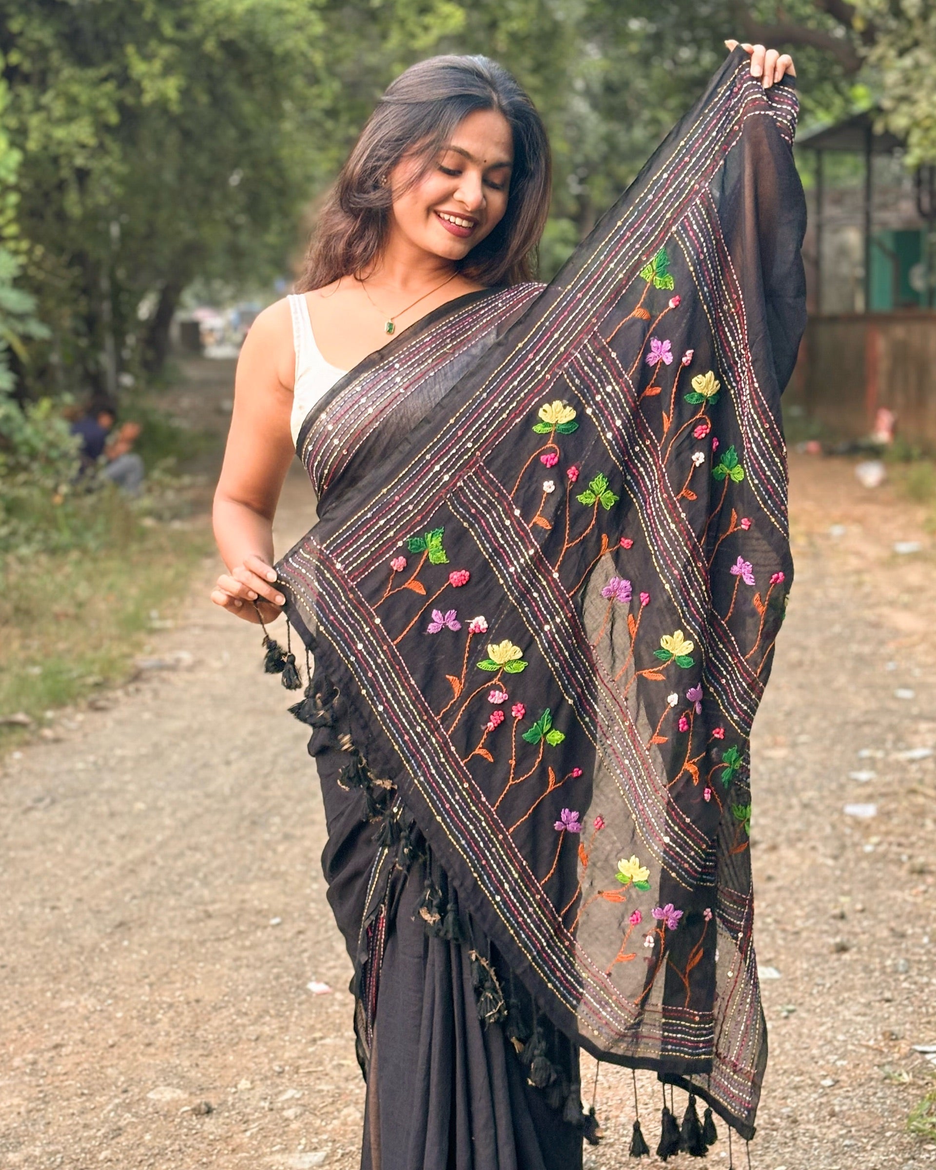 Lightweight black mulmul cotton saree with intricate embroidery for festive styling