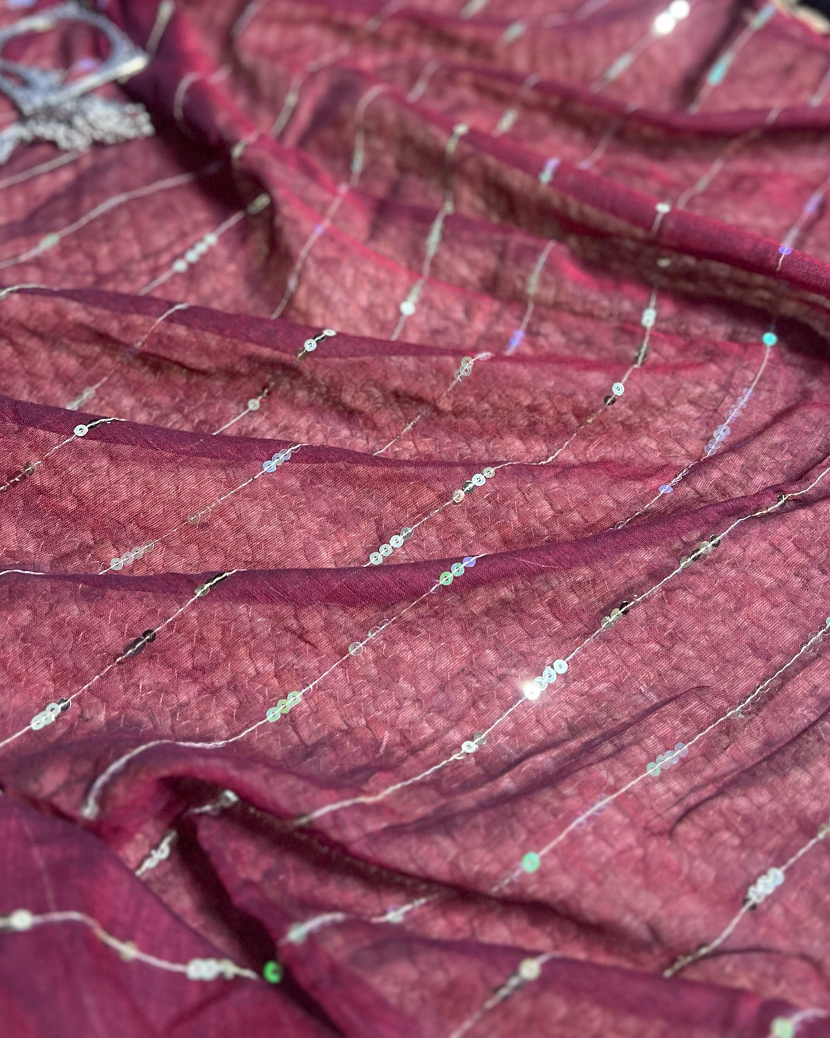 Patakha maroon saree crafted with breathable mulmul fabric and festive charm