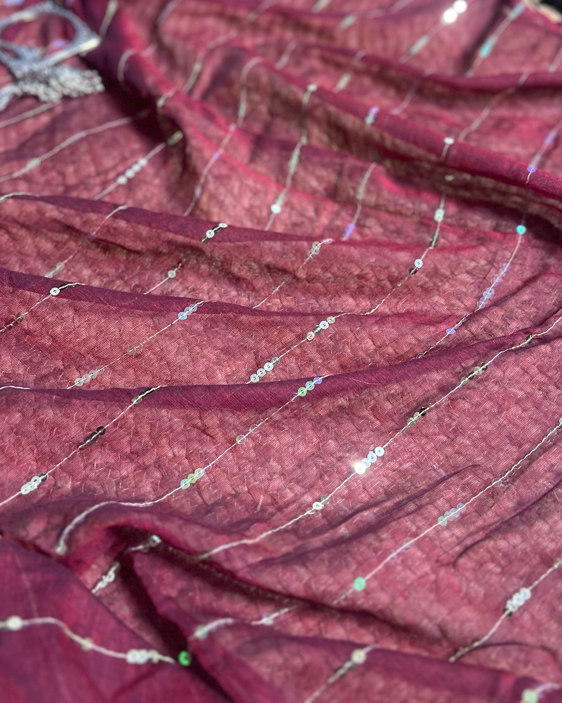 Patakha maroon saree crafted with breathable mulmul fabric and festive charm