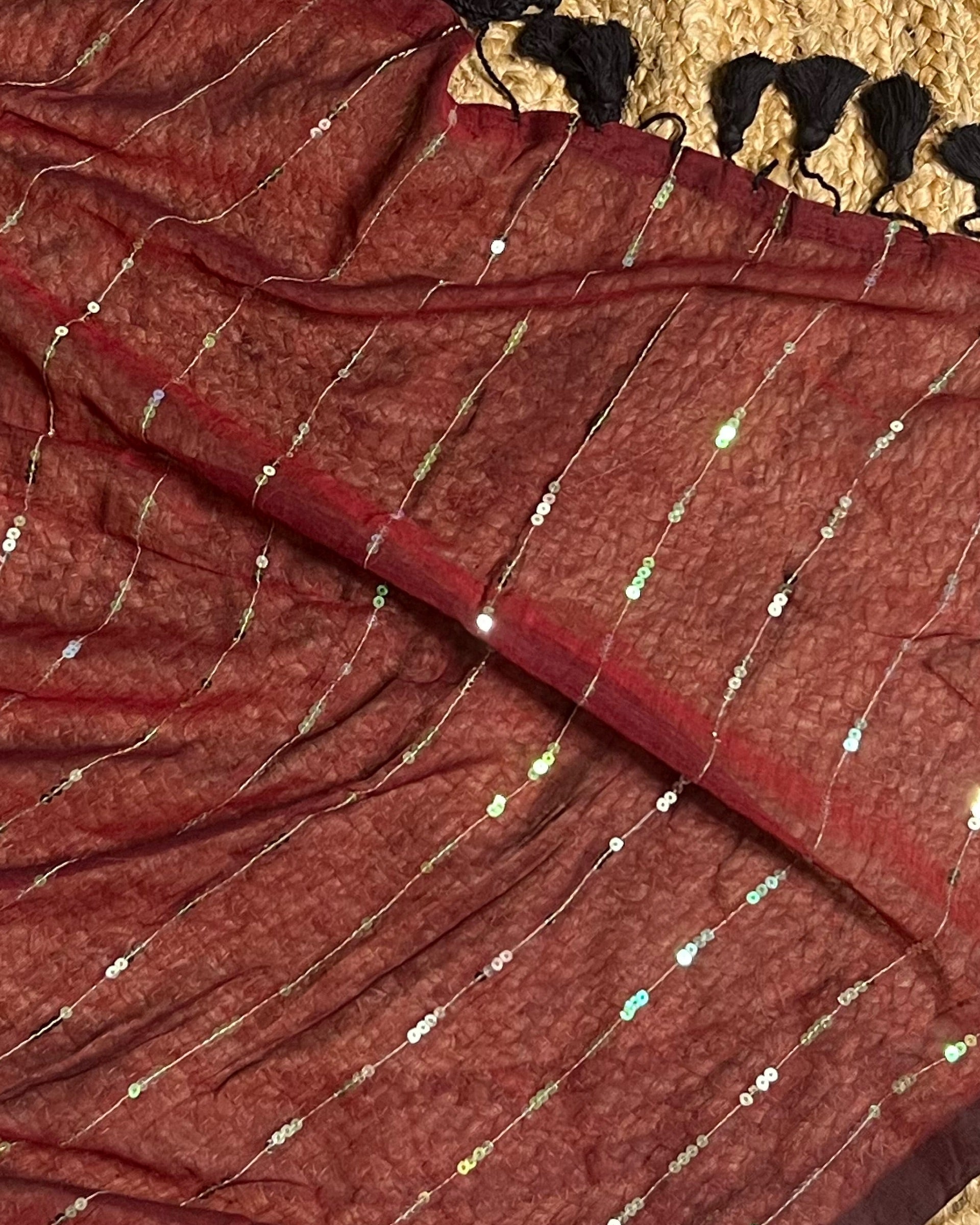 Embellished maroon cotton saree featuring graceful sequins and ethnic appeal