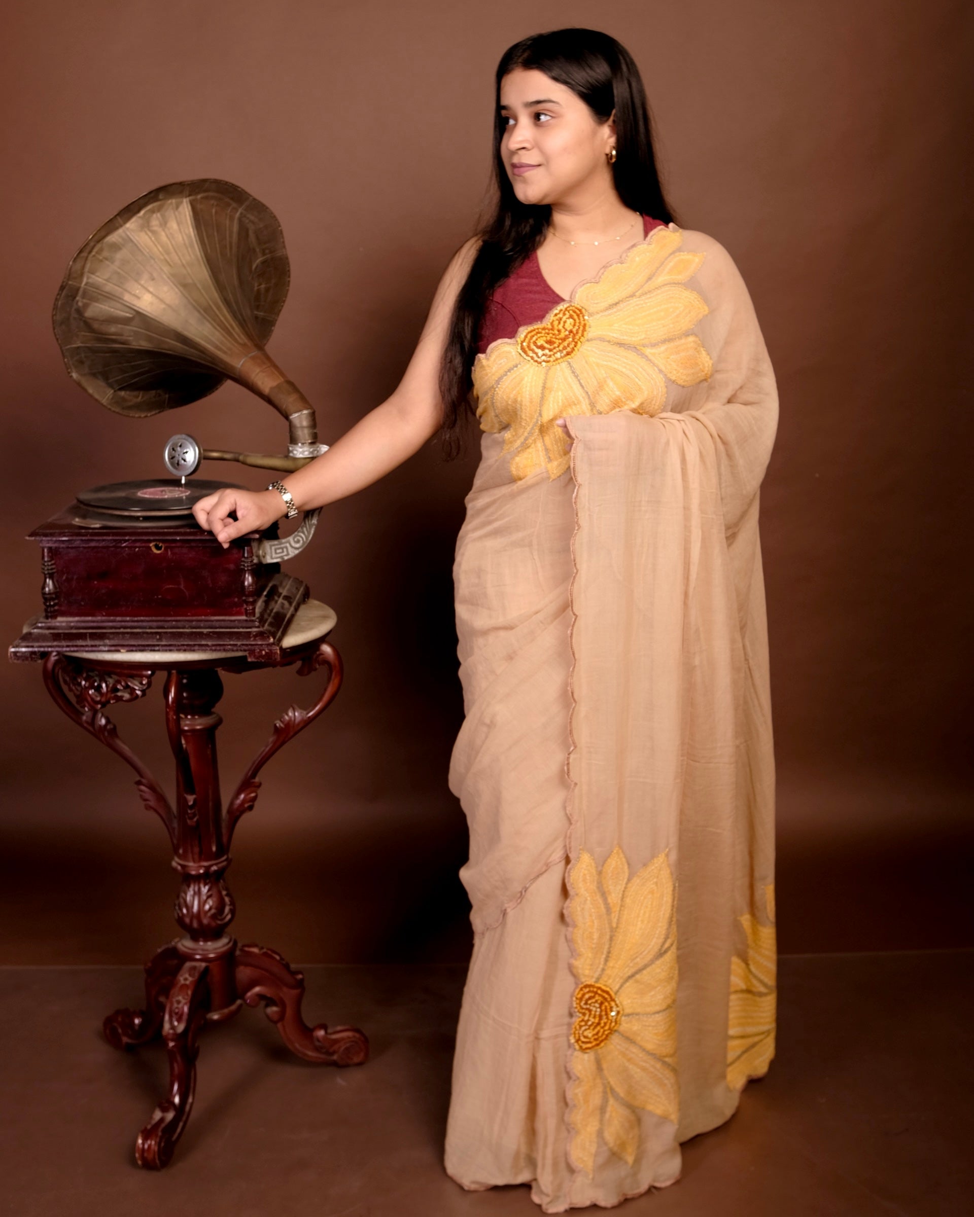 Beige mulmul cotton saree with delicate embroidery, lightweight comfort for minimal and graceful everyday wear.