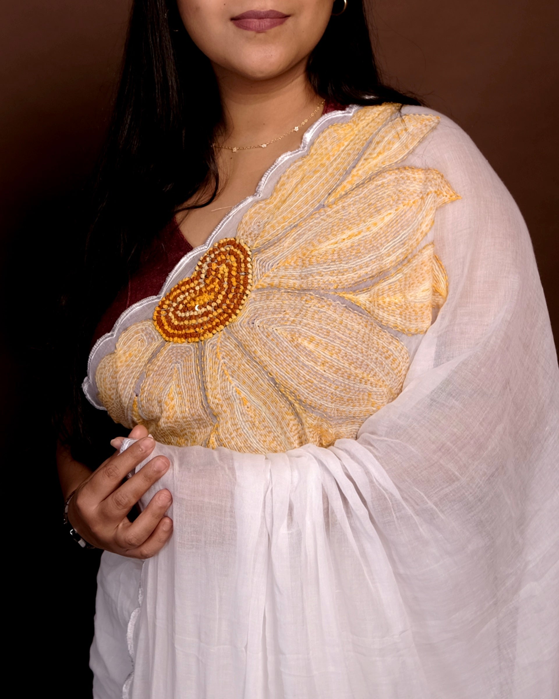 Sunshine Bloom white embroidered mulmul cotton saree with sunflower motifs, a lightweight breathable saree for summer and festive wear.