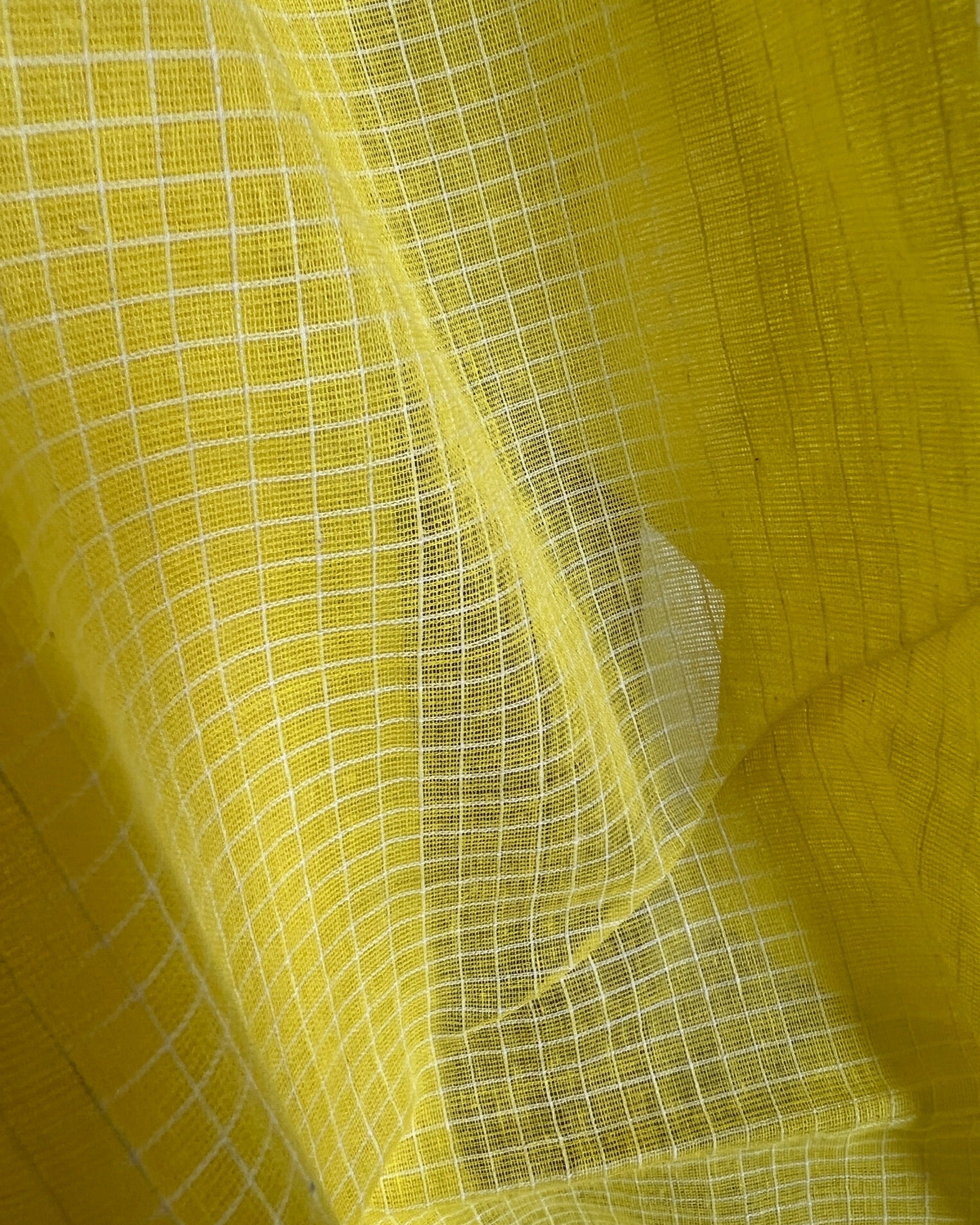 Close-up of yellow check handloom saree by Shopaame named Droupadi