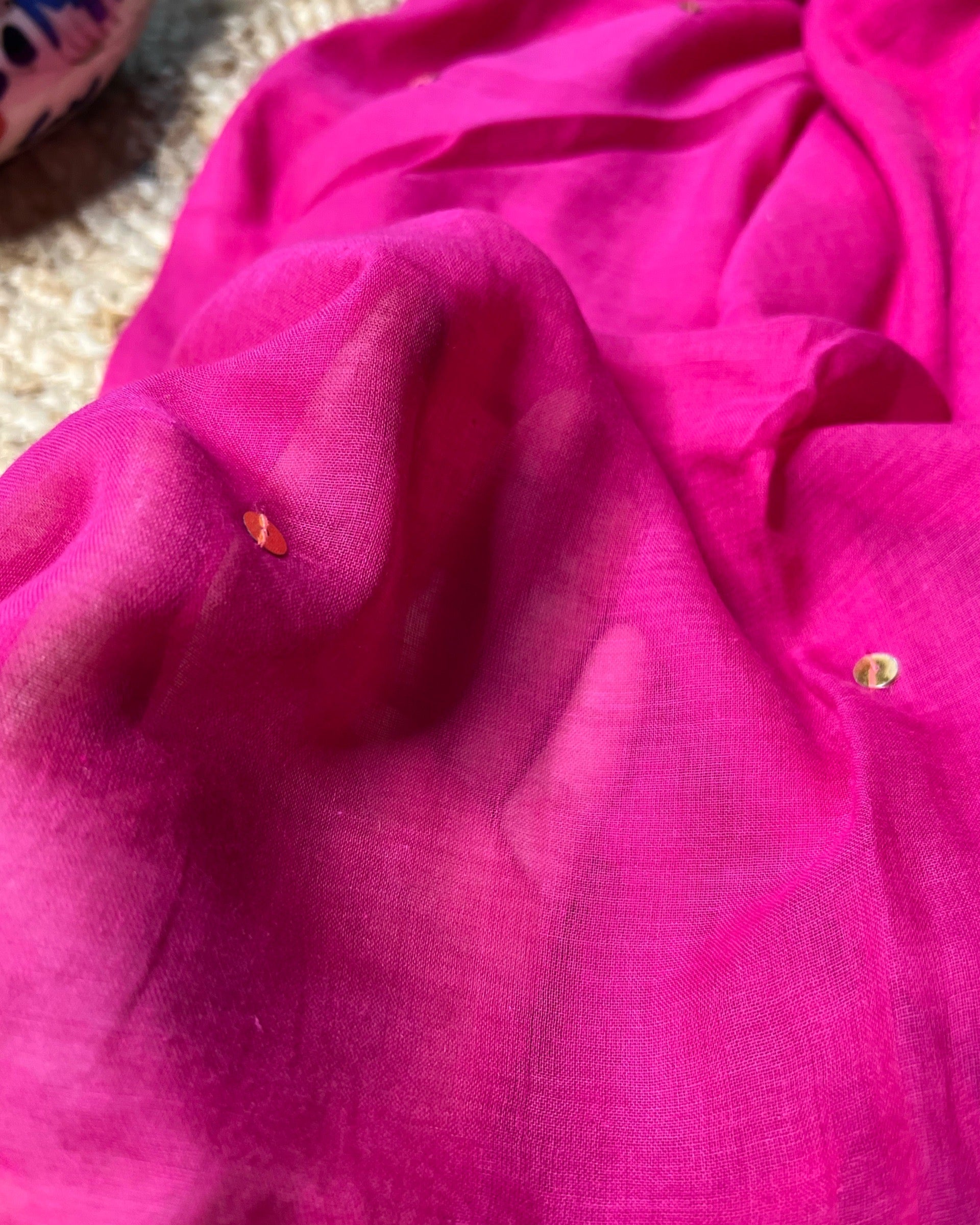 Soft and Comfortable mulmul cotton saree in rani pink shade with golden sequin emblishment for festive or party wear at reasonable price