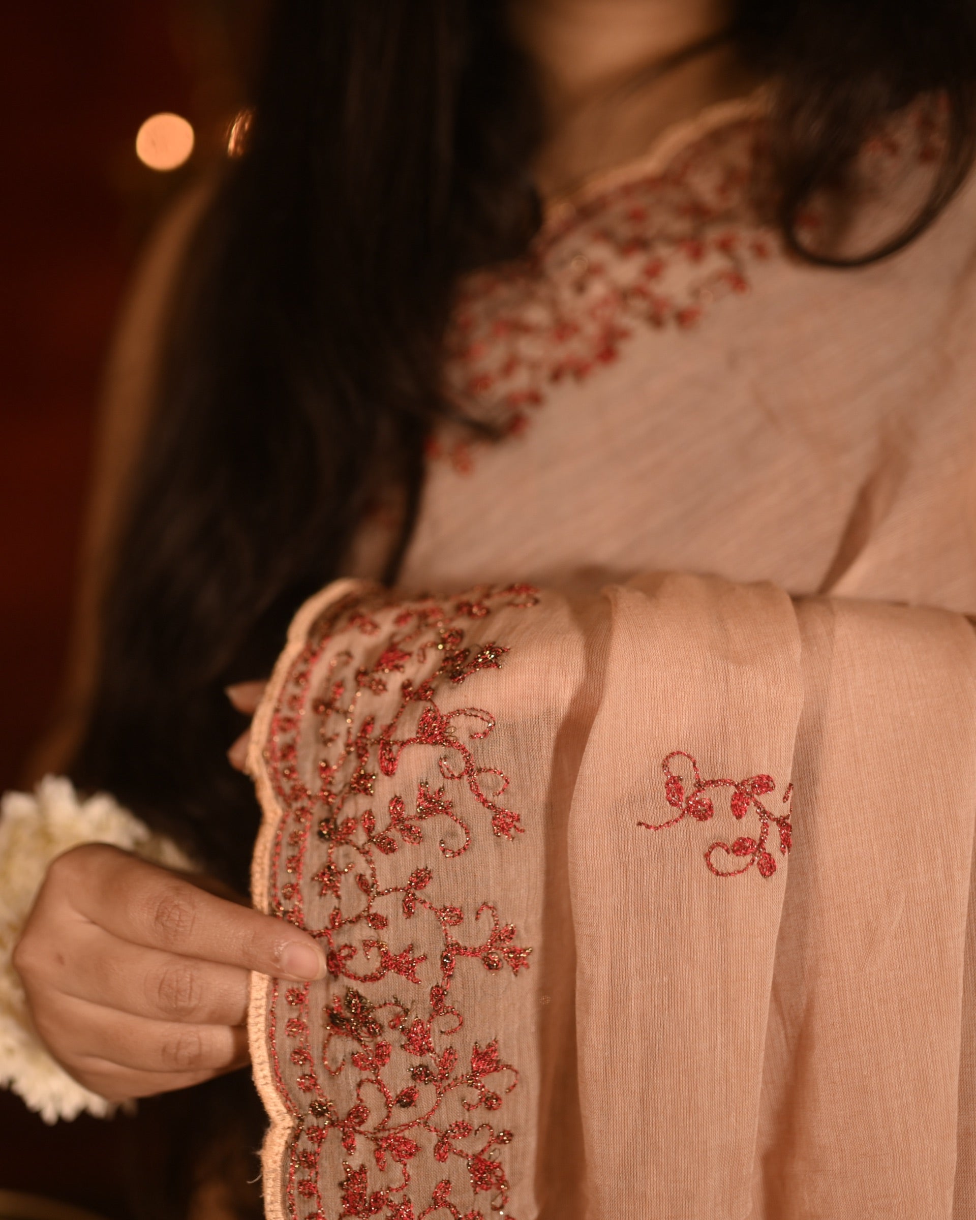 Lightweight brown taupe zari embroidered mulmul cotton saree, designed for festive wear with soft airy comfort.