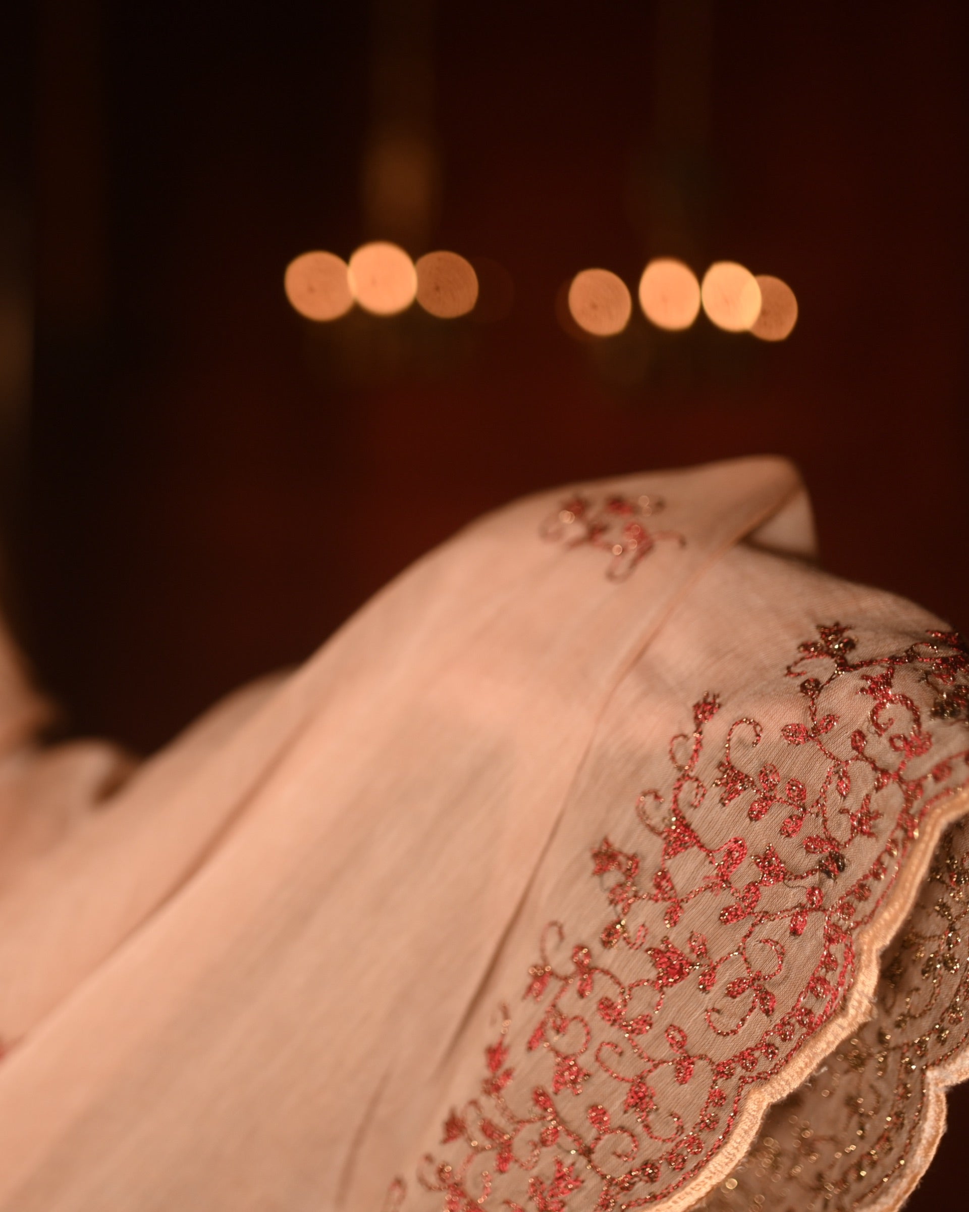 Lightweight brown taupe zari embroidered mulmul cotton saree, designed for festive wear with soft airy comfort.