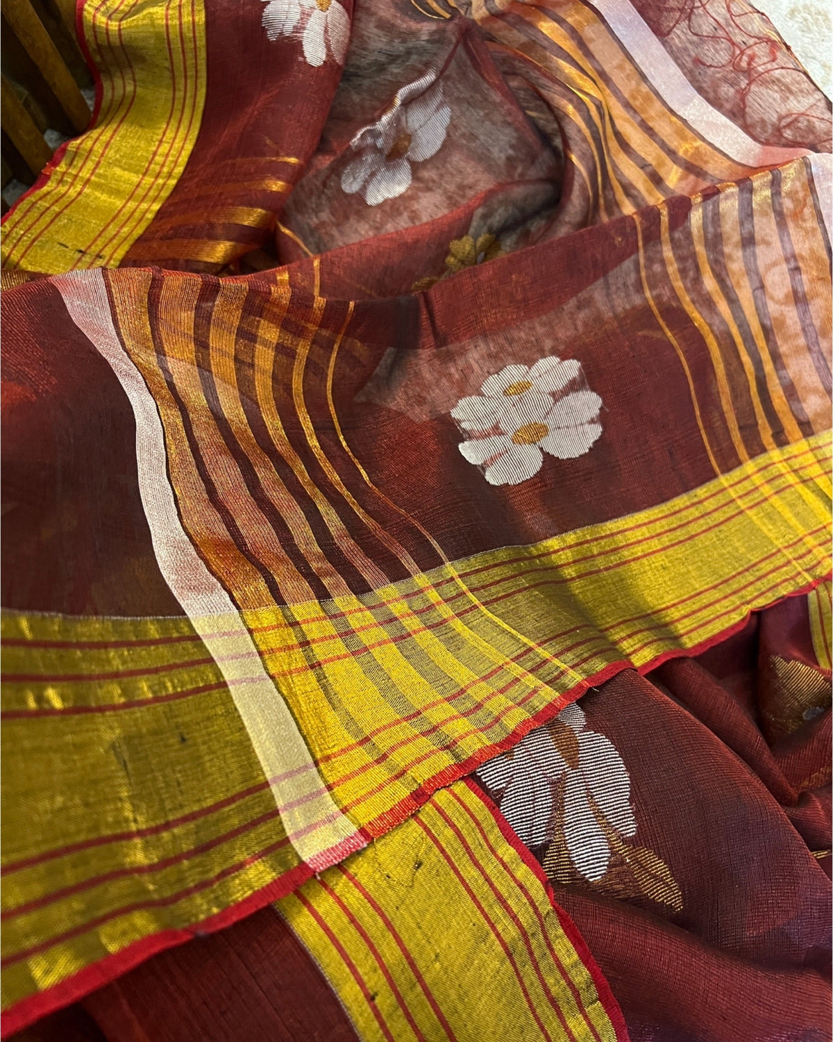 Maroon golden festive saree with soft tissue fabric and graceful ethnic appeal