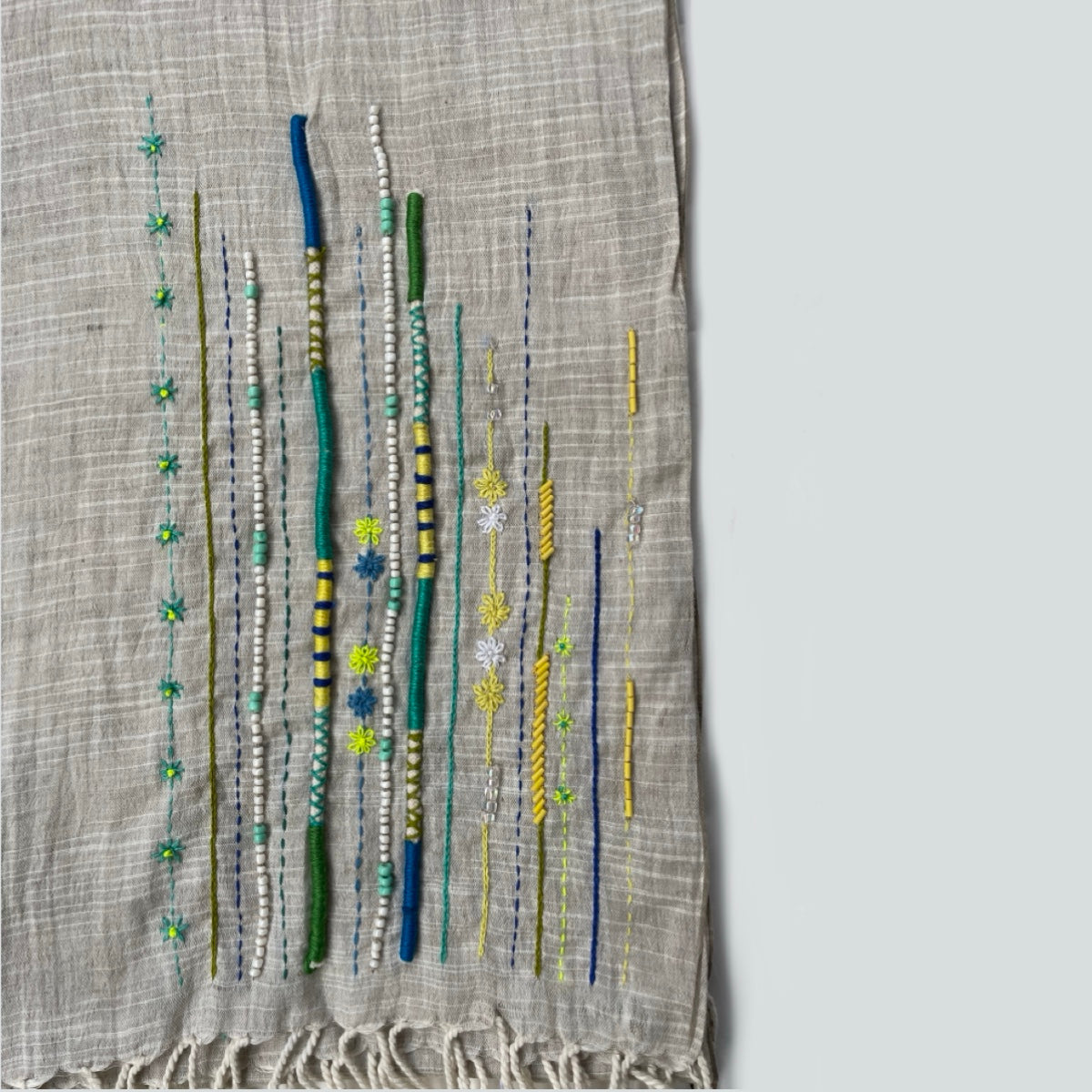 Close-up of embroidered and beaded handwoven scarf