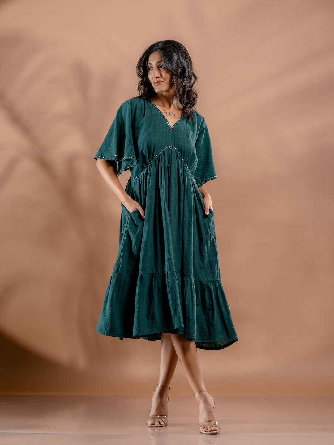 Front view of teal green summer cotton dress with relaxed fit and pocket details