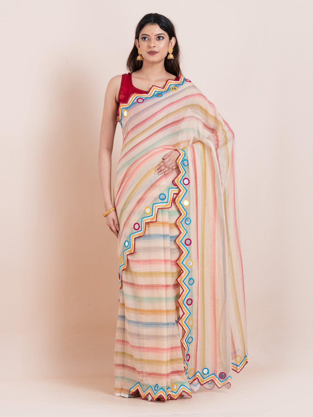 Lightweight peach mulmul cotton saree with mirror embroidery and multicolored stripes.