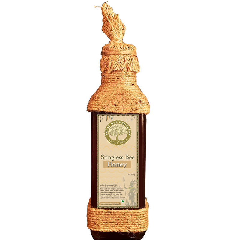Bottle of Stingless Bee Honey with a decorative top on a white background
