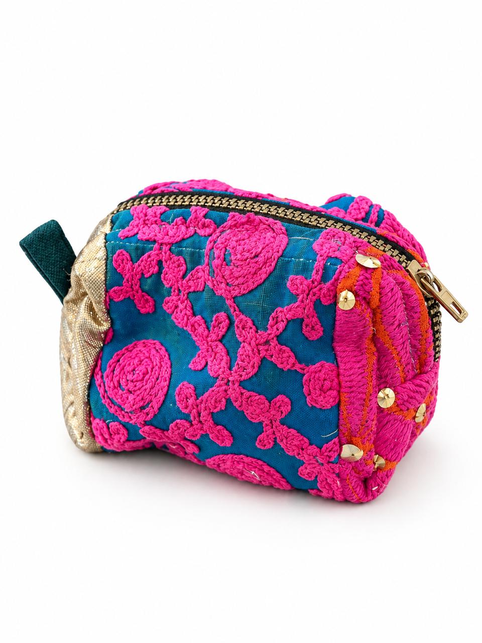 A compact, hand-embroidered mini pouch featuring vibrant pink threadwork on a rich teal base, accented with intricate detailing and a touch of gold. Perfect for carrying your everyday essentials, it adds a playful, festive touch to any look.