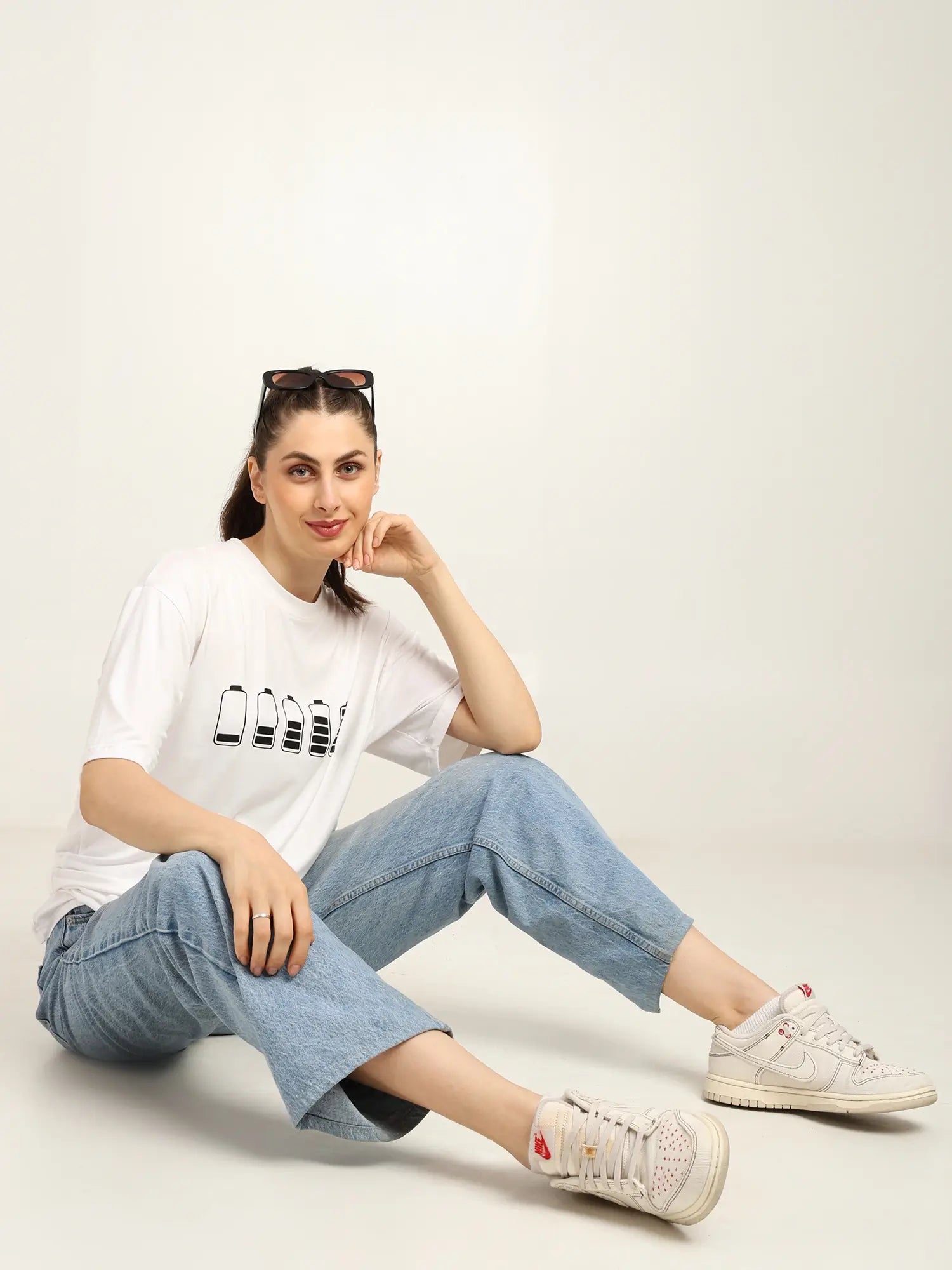 Model wearing a trendy oversized bamboo T-shirt with casual denim and sneakers, showcasing sustainable streetwear style.
