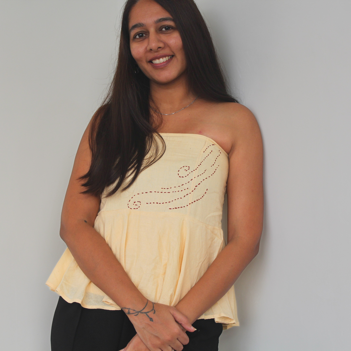 Woman wearing a beige strapless top