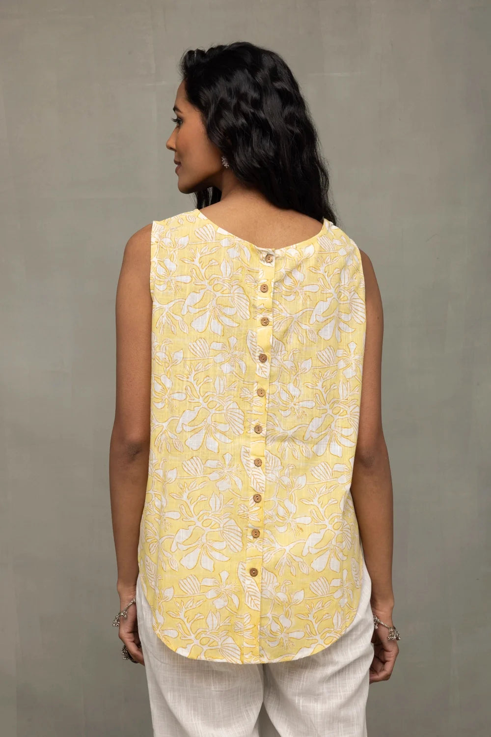 Back View of Sunshine Yellow Top Showcasing White Print and Buttoned Back Pattern
