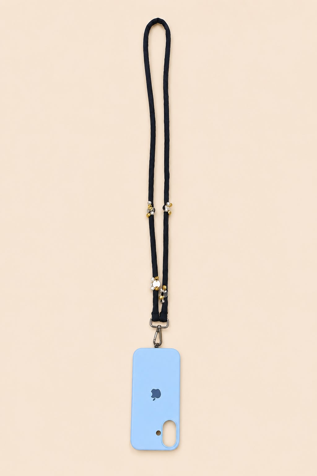 A light blue phone case with a black lanyard strap and gold-tone hardware, shown flat against a solid pale beige background.
