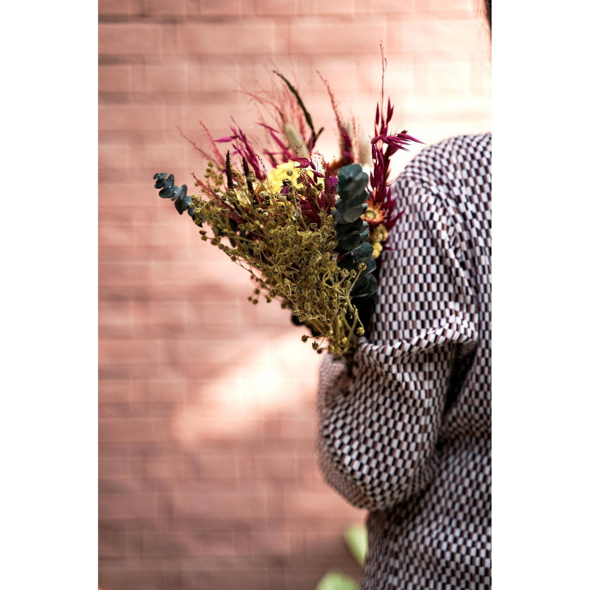 Close up of mixed dried flower bouquet with natural decorative stems